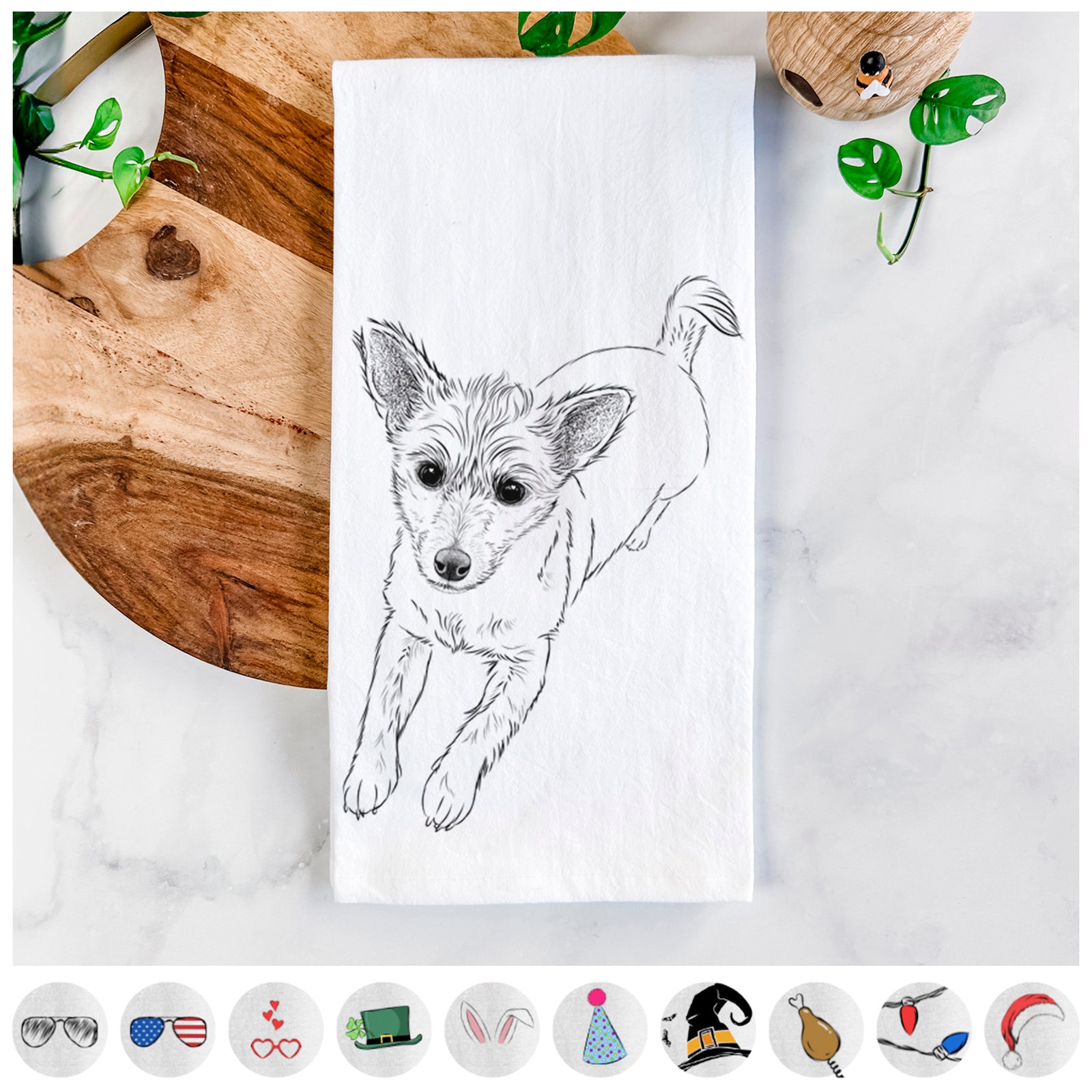 Hand-drawn sketch of Maisie the Terrier Mix on a tea towel, shown with icons of the other available costume styles