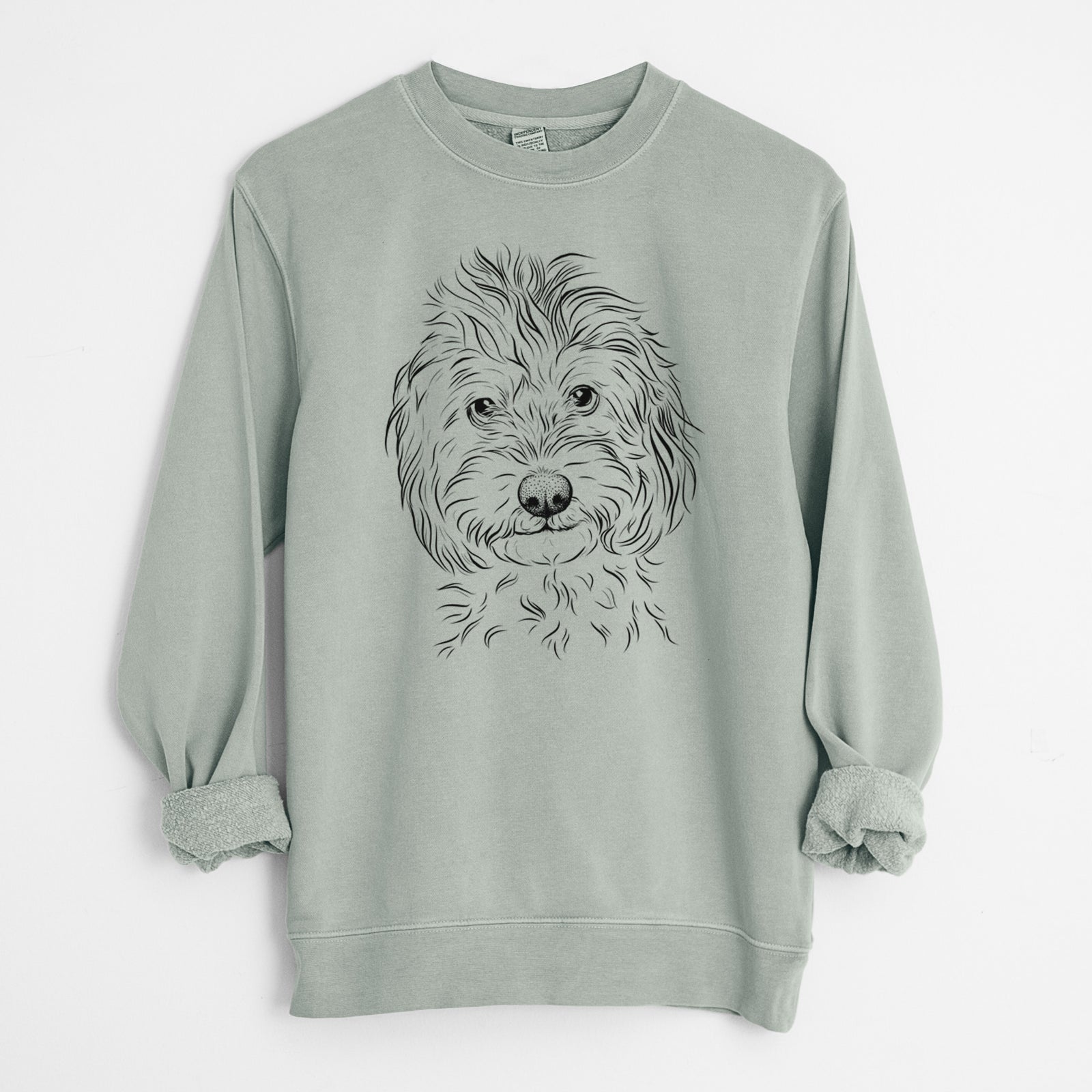 Hand-drawn sketch of Mason the Cavapoo on a Sage Unisex pigment dyed crew sweatshirt