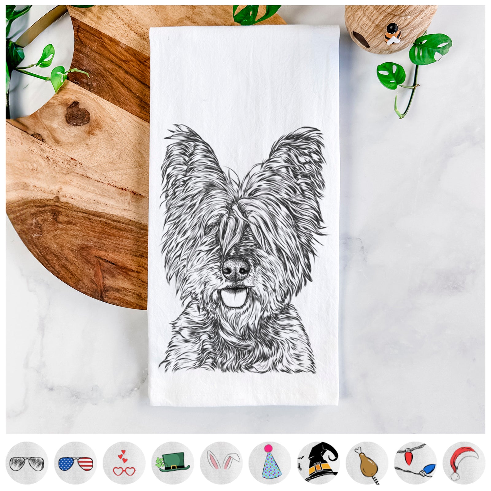 Hand-drawn sketch of McDuff the Cairn Terrier on a tea towel, shown with icons of the other available costume styles