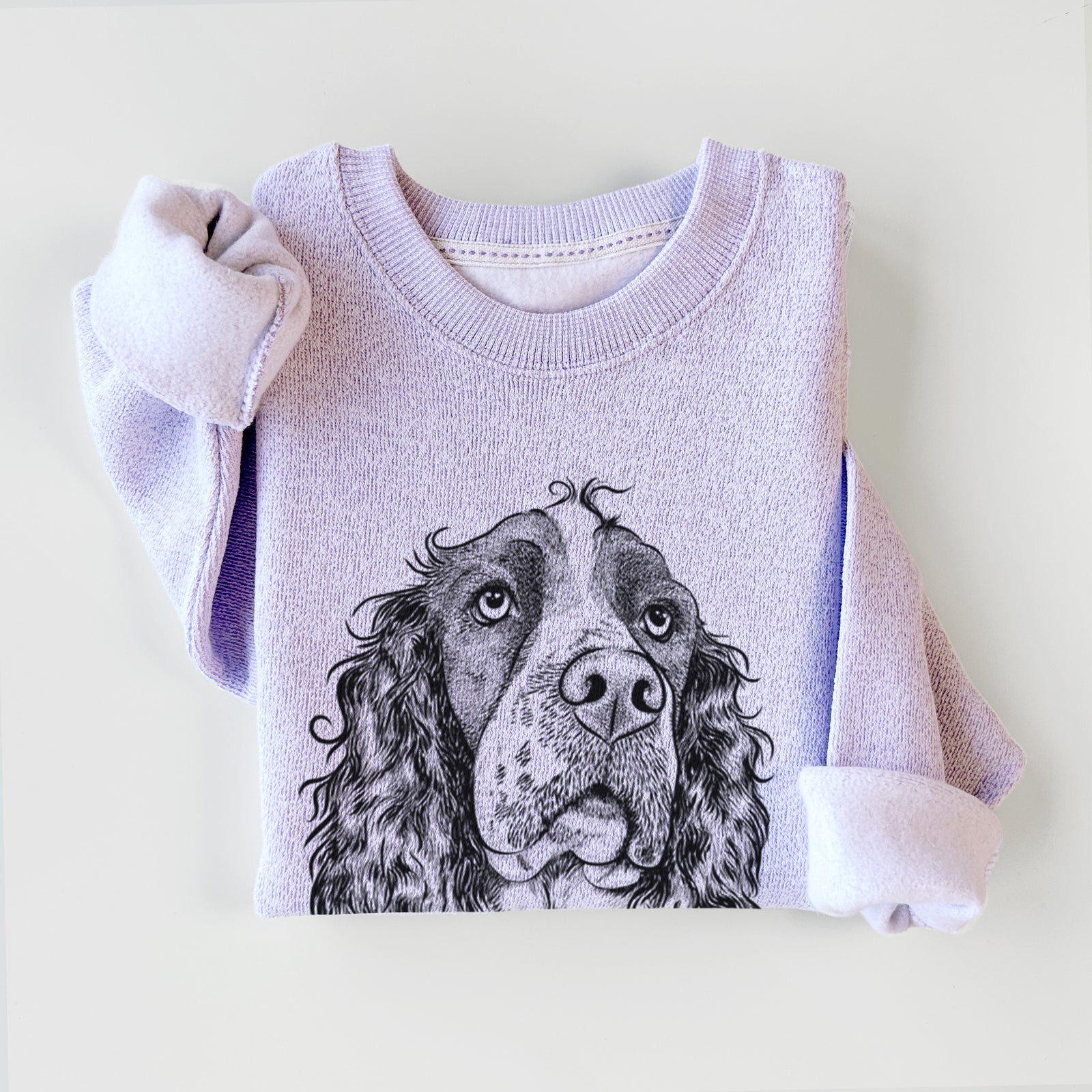 Hand-drawn sketch of Millie Mae the English Springer Spaniel on an Ice Purple knit sweatshirt