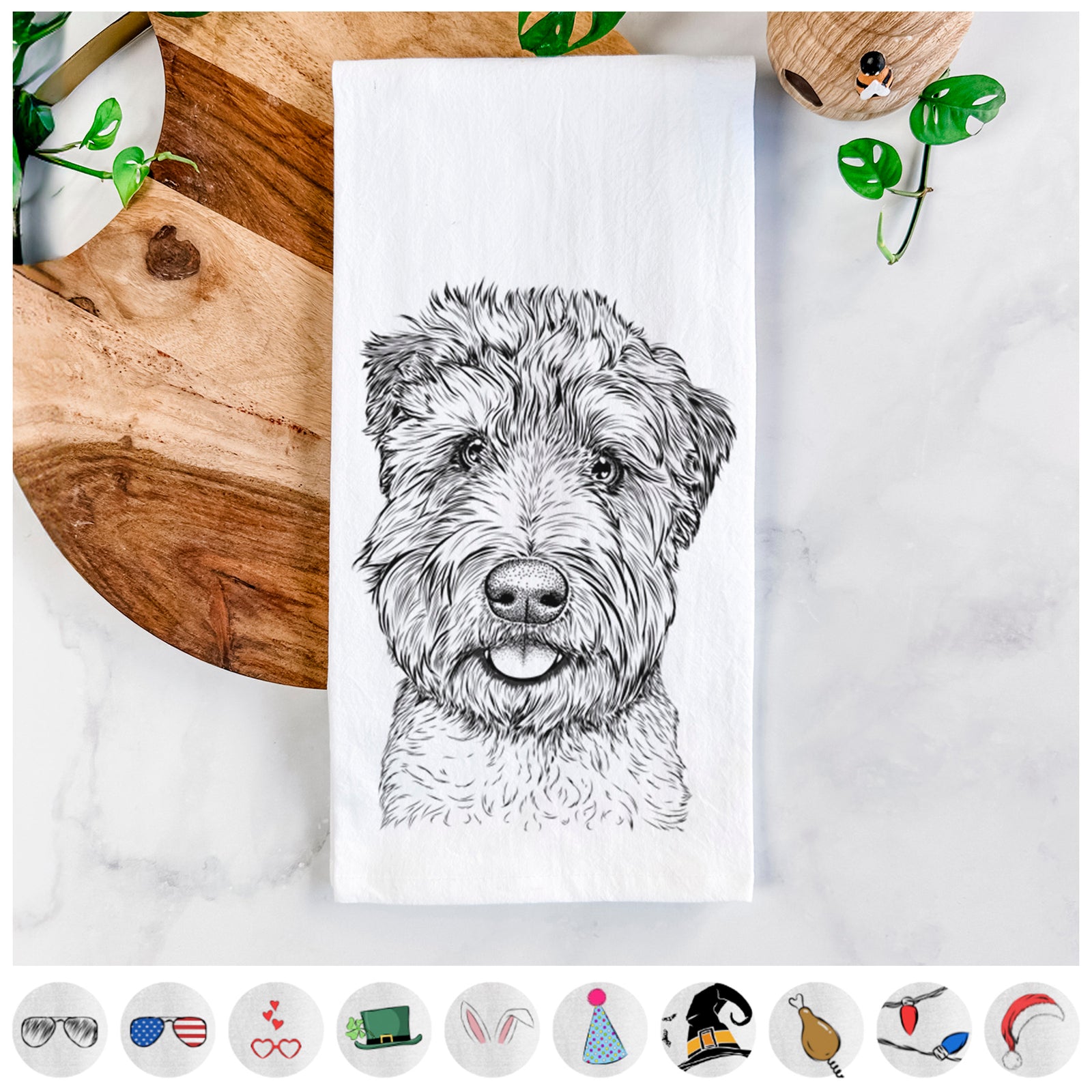Hand-drawn sketch of Milton the Soft Coated Wheaten Terrier on a tea towel, shown with icons of the other available costume styles