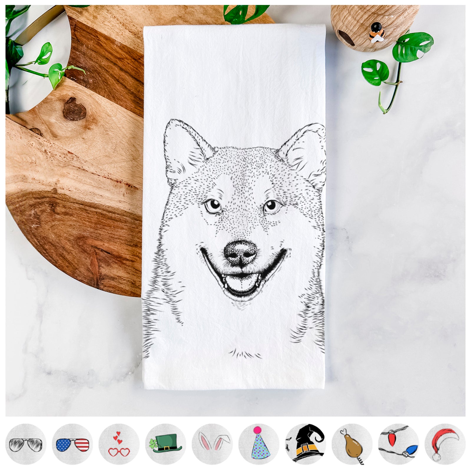 Hand-drawn sketch of Mitsu the Shiba Inu on a tea towel, shown with icons of the other available costume styles