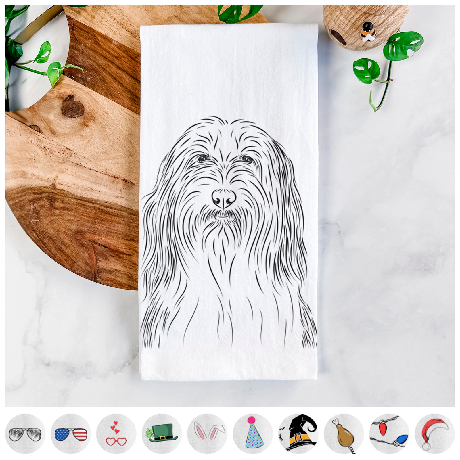 Hand-drawn sketch of Murray the Bearded Collie on a tea towel, shown with icons of the other available costume styles