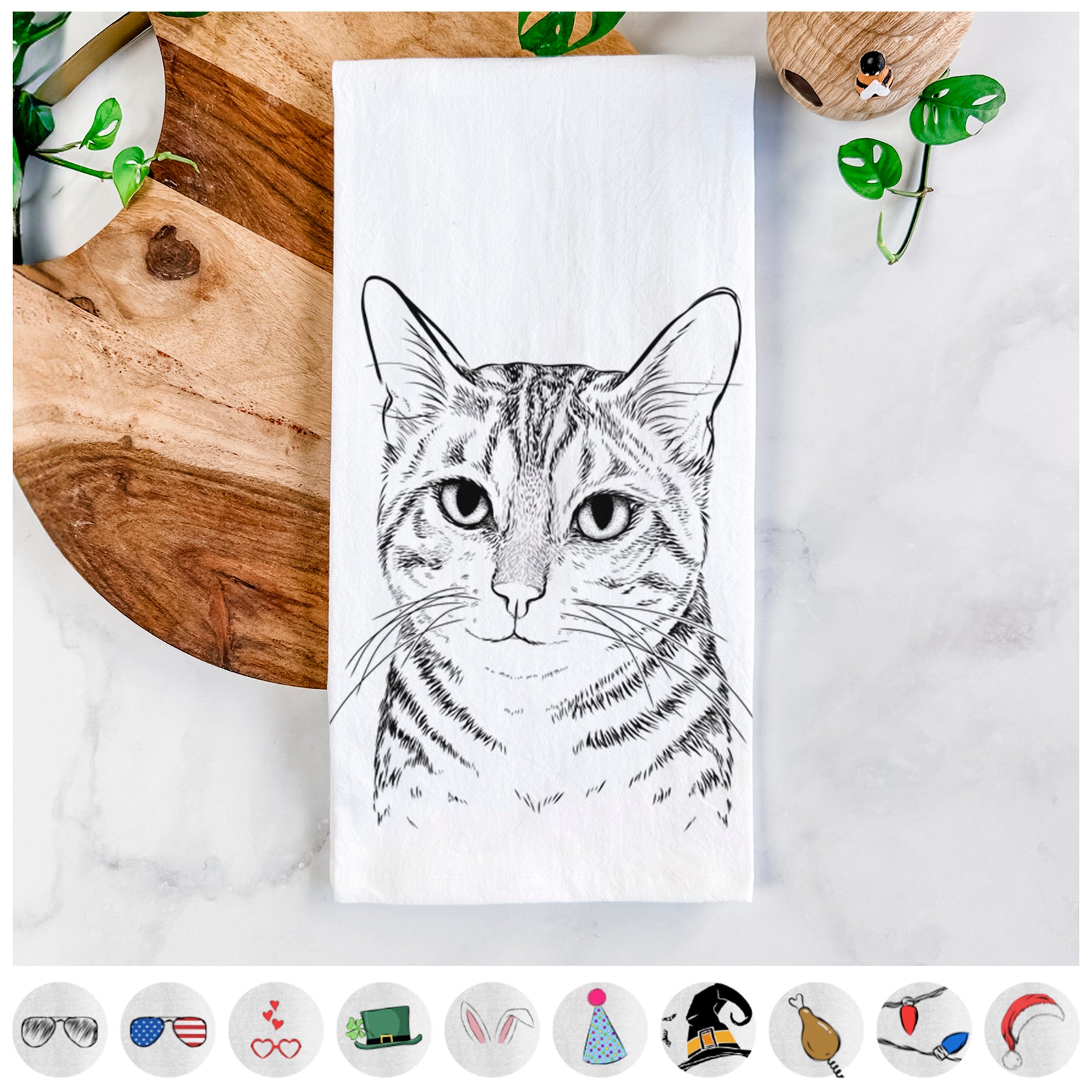 Hand-drawn sketch of Nell the Tabby Cat on a tea towel, shown with icons of the other available costume styles