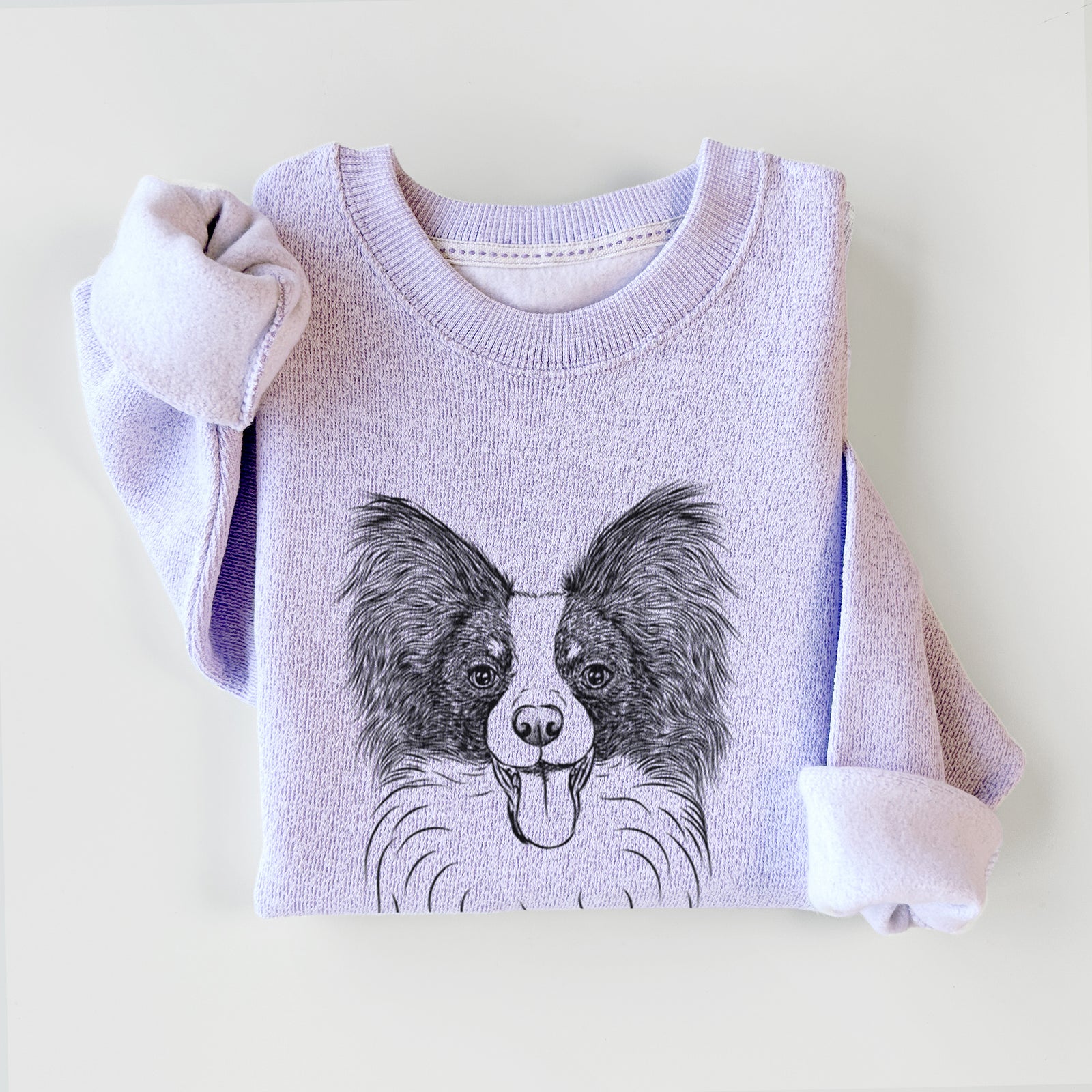 Hand-drawn sketch of Patrick the Papillon on an Ice Purple knit sweatshirt