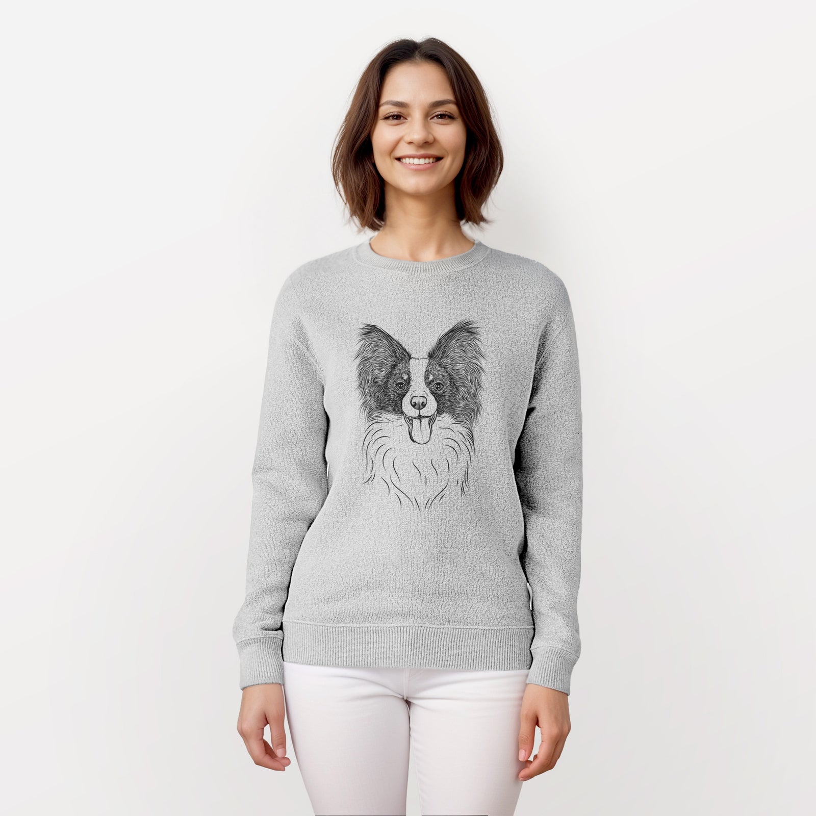 Hand-drawn sketch of Patrick the Papillon on a knit sweatshirt, worn by a woman