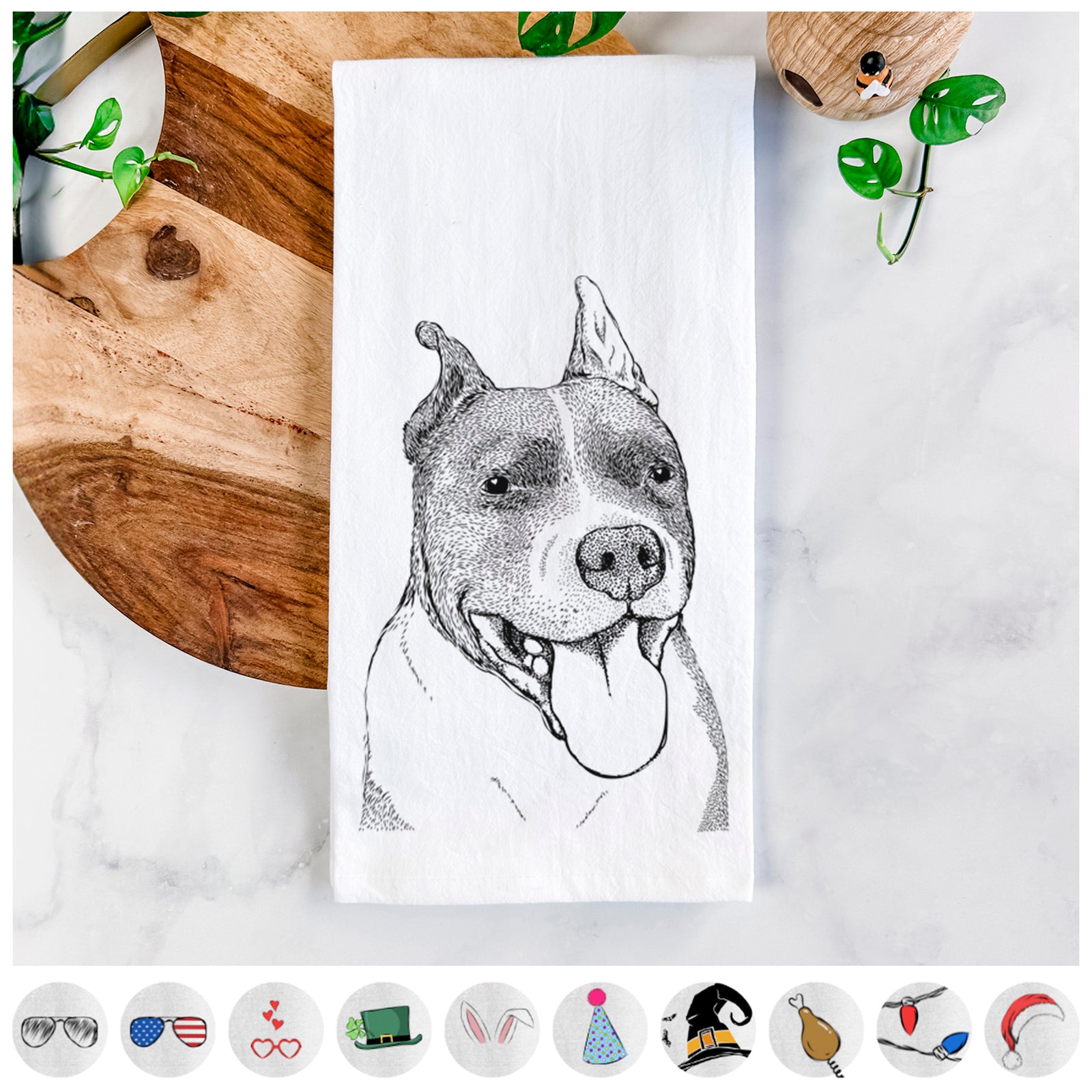 Hand-drawn sketch of Piggy the American Staffordshire Terrier on a tea towel, shown with icons of the other available costume styles