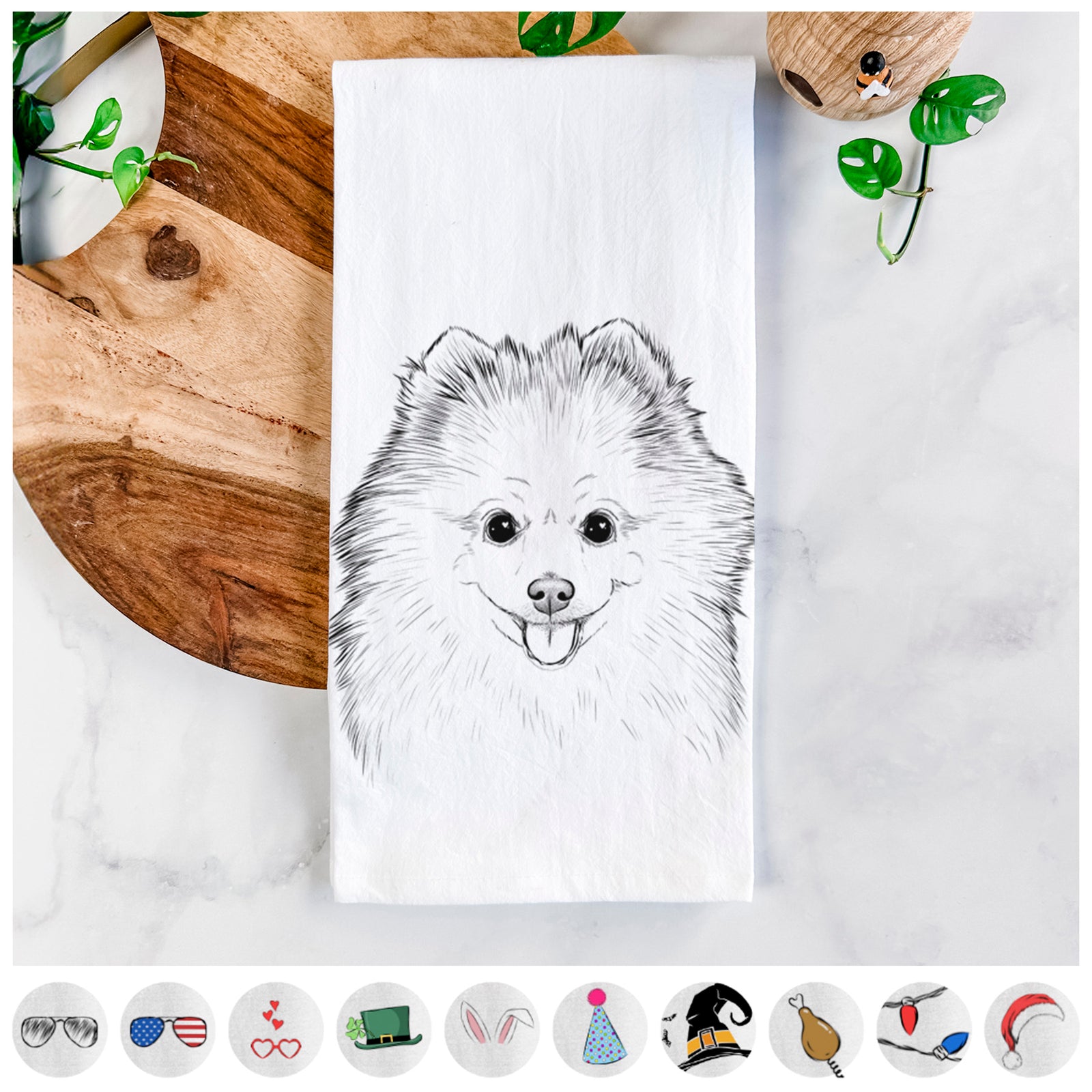Hand-drawn sketch of Piper Jo the Pomeranian on a tea towel, shown with icons of the other available costume styles