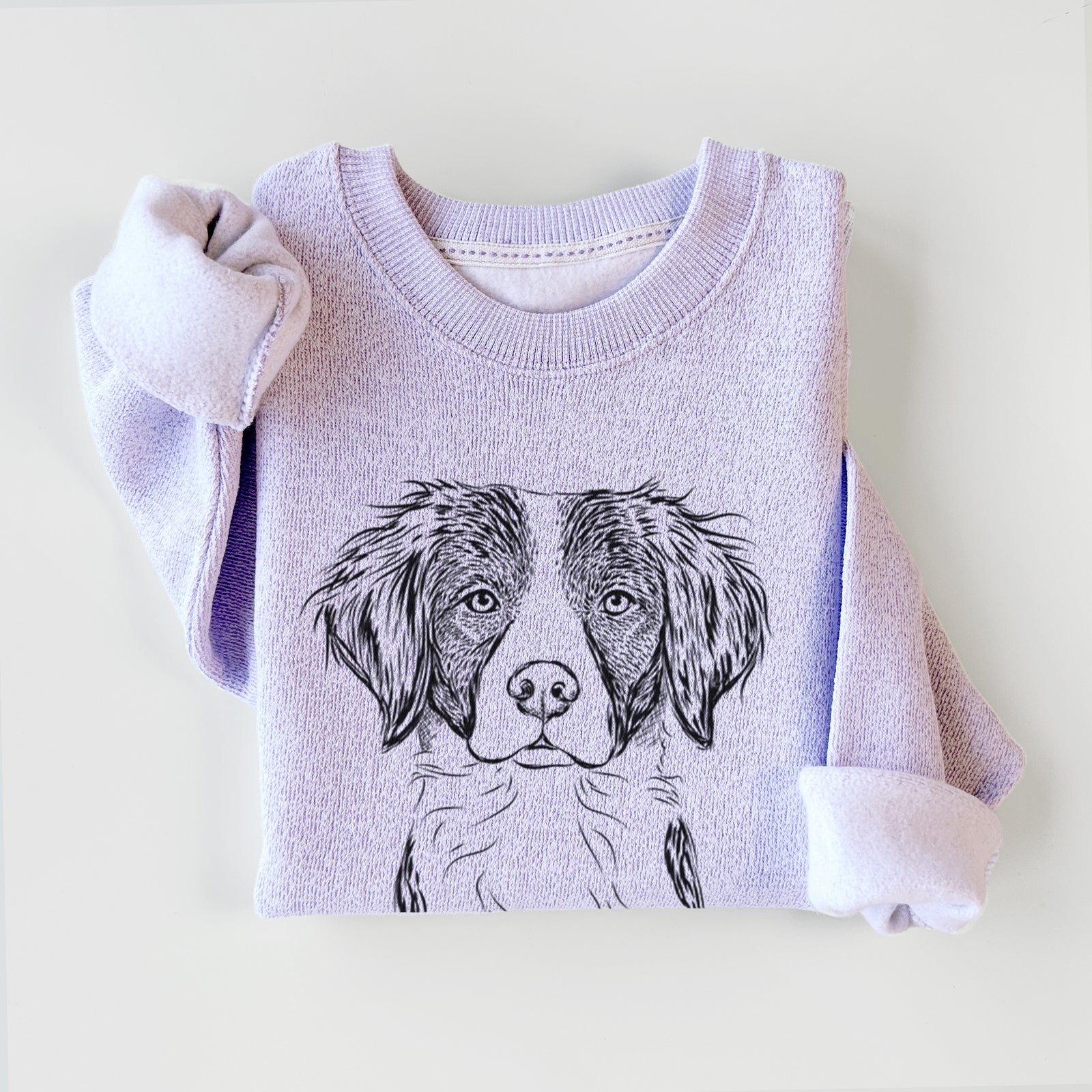 Hand-drawn sketch of Remi the Brittany on an Ice Purple knit sweatshirt