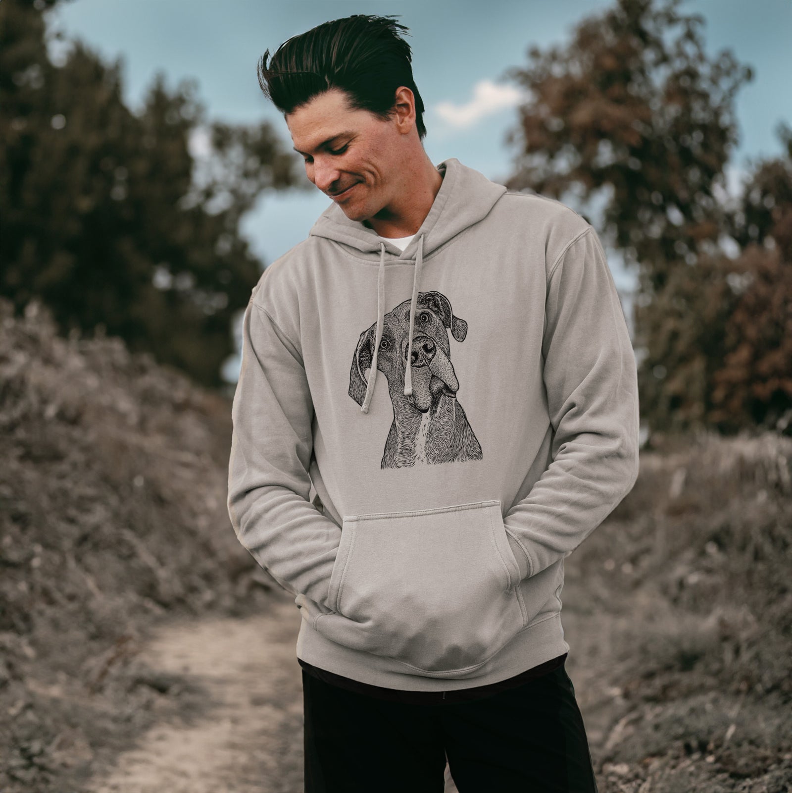 Hand-drawn sketch of River the Great Dane on a Cement Unisex pigment dyed hoodie, worn by a man