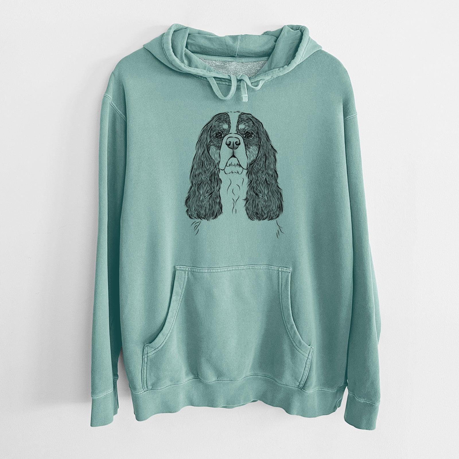 Hand-drawn sketch of Sebastian the Cavalier King Charles Spaniel on a Mint Unisex pigment dyed hoodie