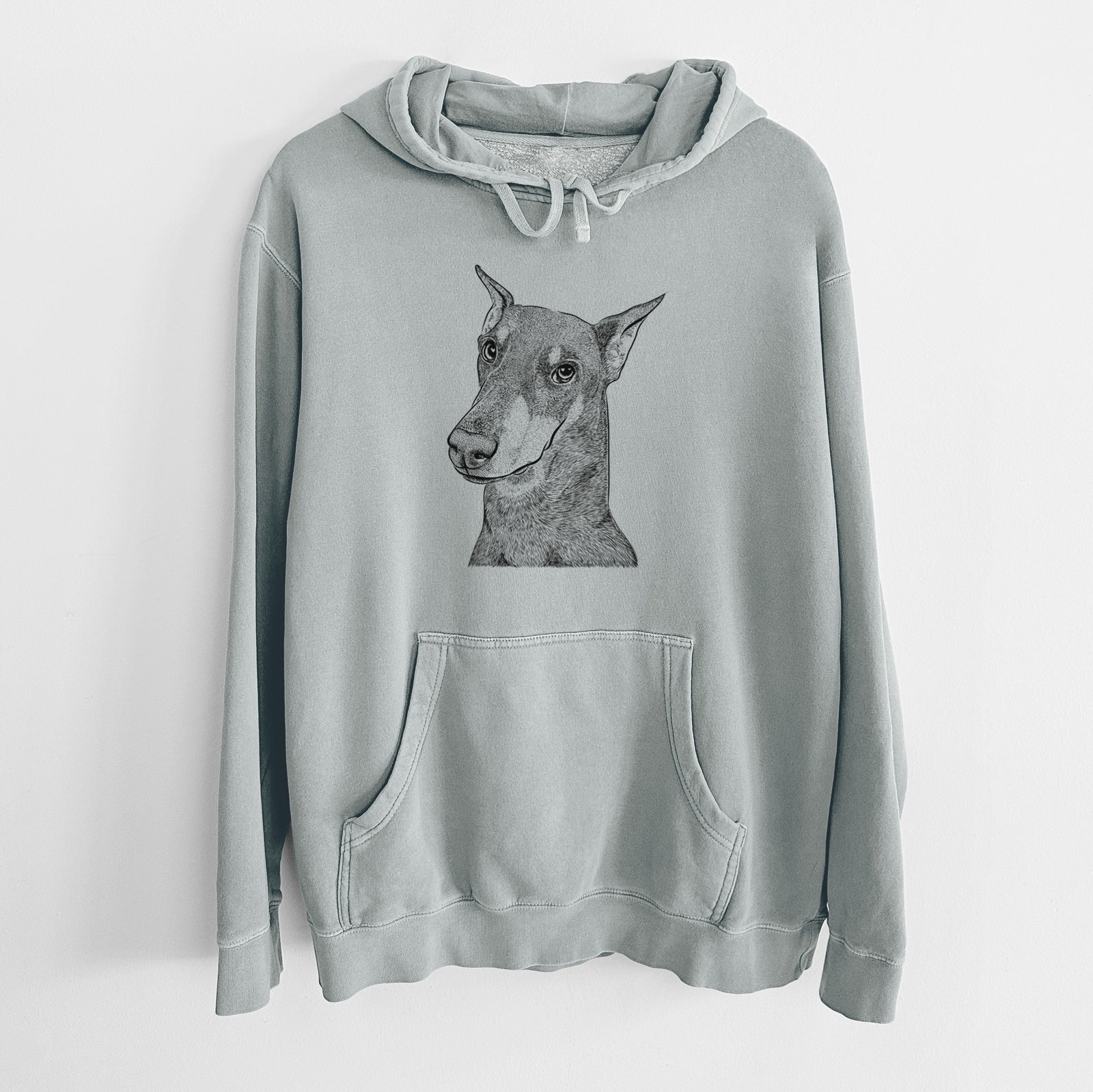 Hand-drawn sketch of Shelby the Doberman Pinscher on a Sage Unisex pigment dyed hoodie