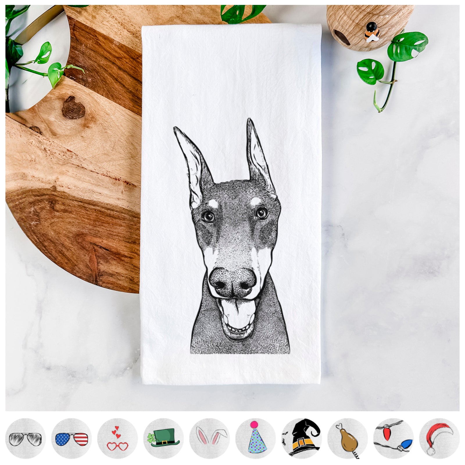 Hand-drawn sketch of Sir Duke the Doberman Pinscher on a tea towel, shown with icons of the other available costume styles