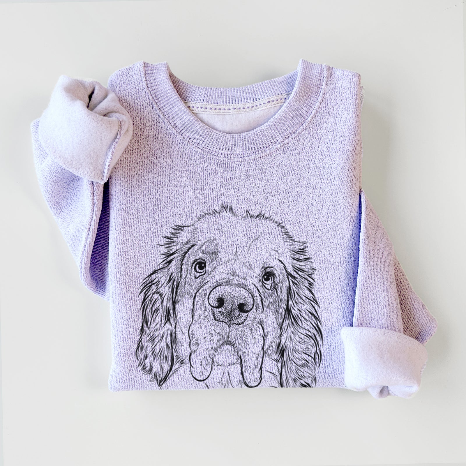 Hand-drawn sketch of Sully the Clumber Spaniel on an Ice Purple knit sweatshirt