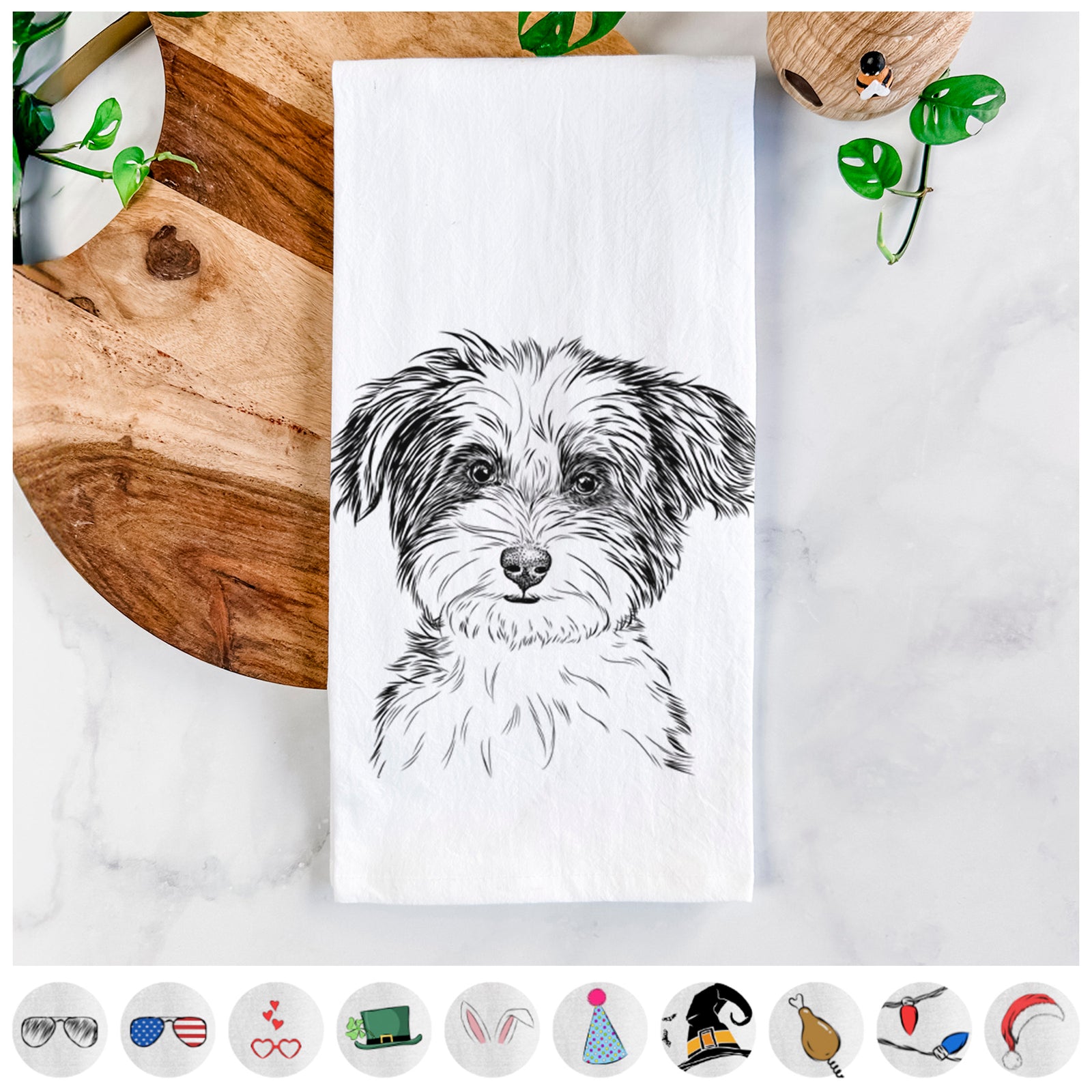 Hand-drawn sketch of Teddy the Havanese on a tea towel, shown with icons of the other available costume styles