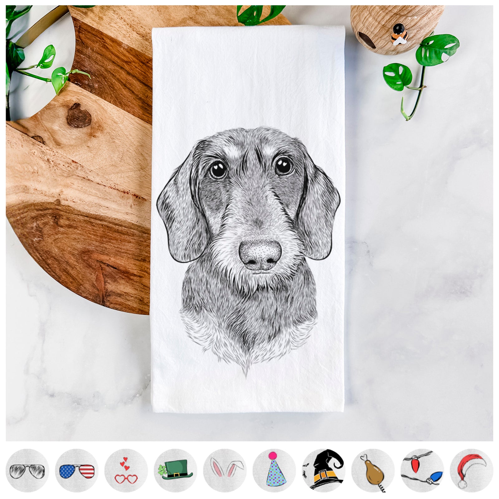 Hand-drawn sketch of Truman the Wirehaired Dachshund on a tea towel, shown with icons of the other available costume styles