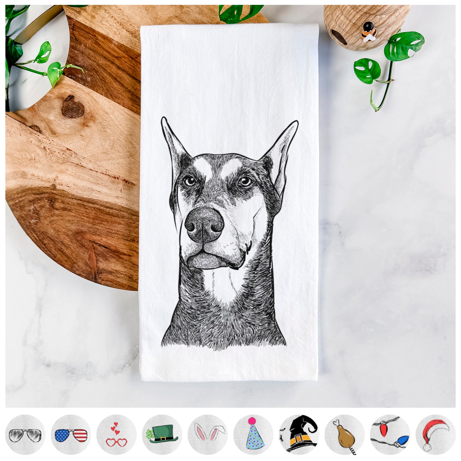 Hand-drawn sketch of Zeus the Doberman Pinscher on a tea towel, shown with icons of the other available costume styles