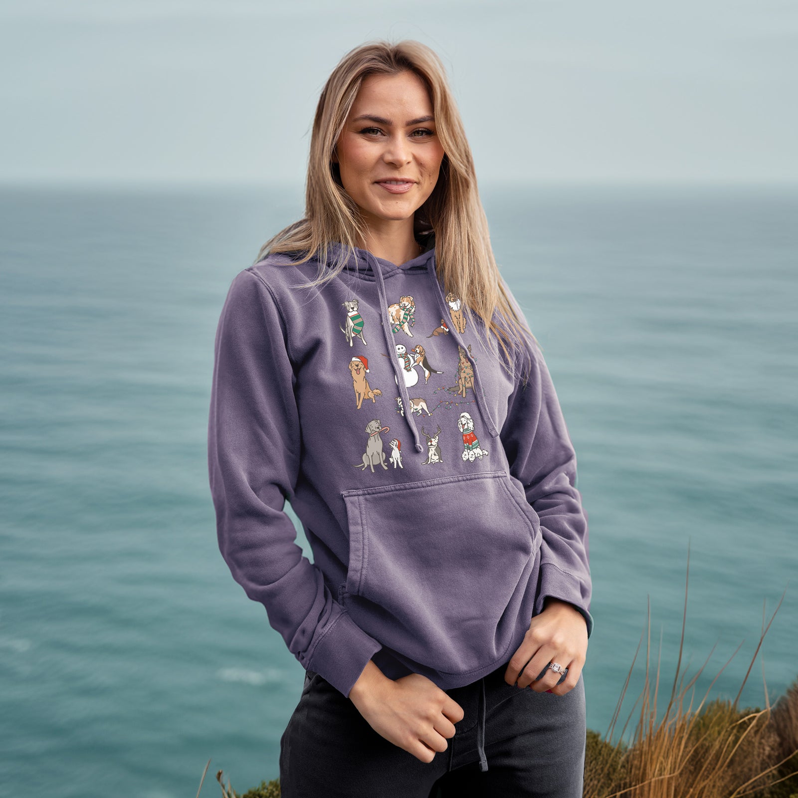 'Christmas Pups' design on a Plum Unisex pigment dyed hoodie, worn by a woman