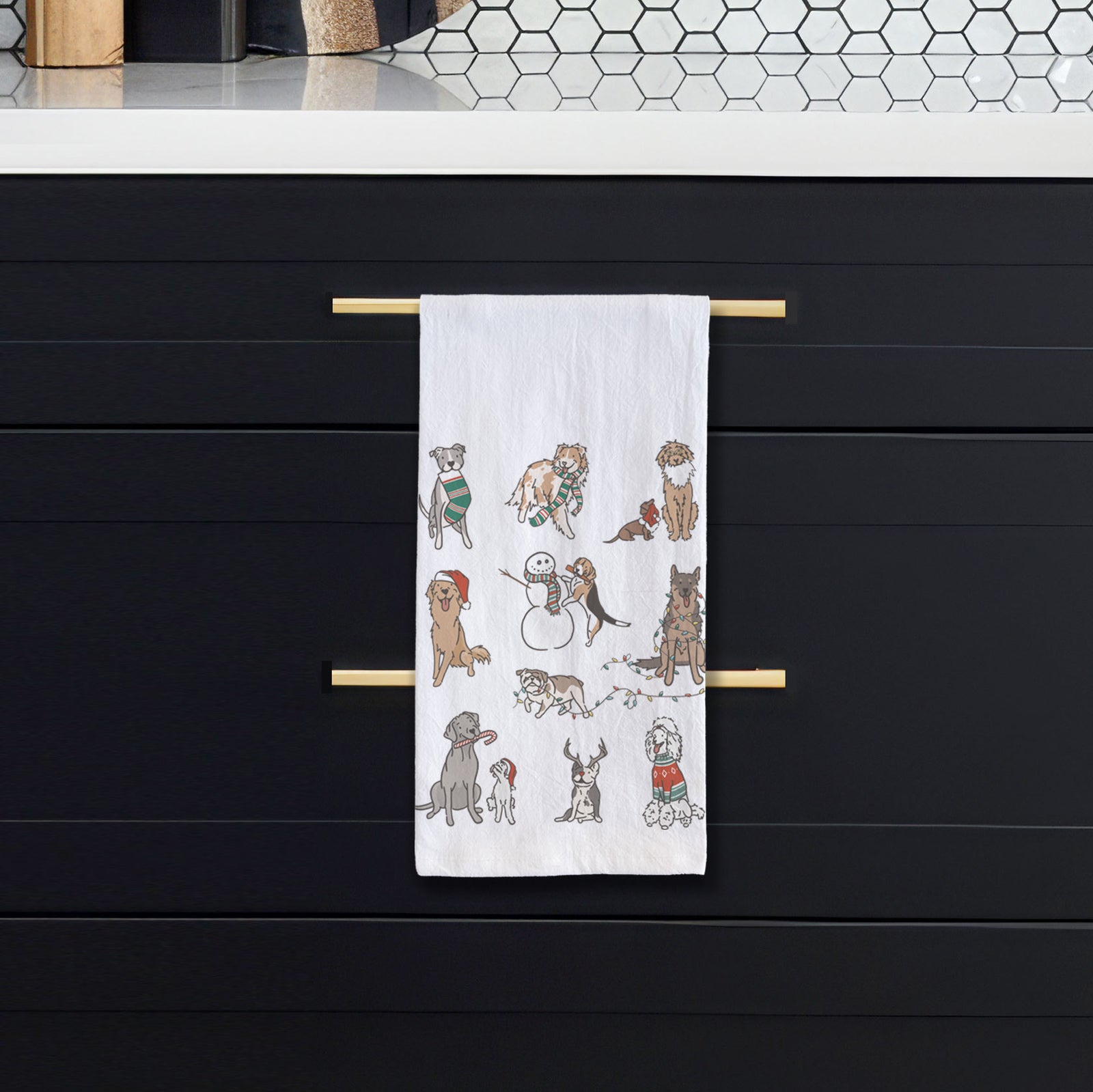 'Christmas Pups' design on a tea towel, hanging on an oven door in a kitchen