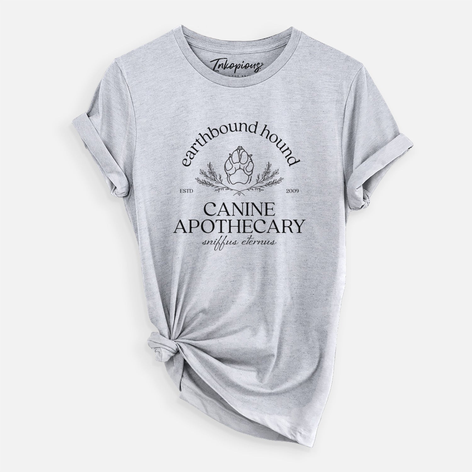 'Earthbound Hound – Canine Apothecary' design on a Grey Unisex crewneck, worn by a woman