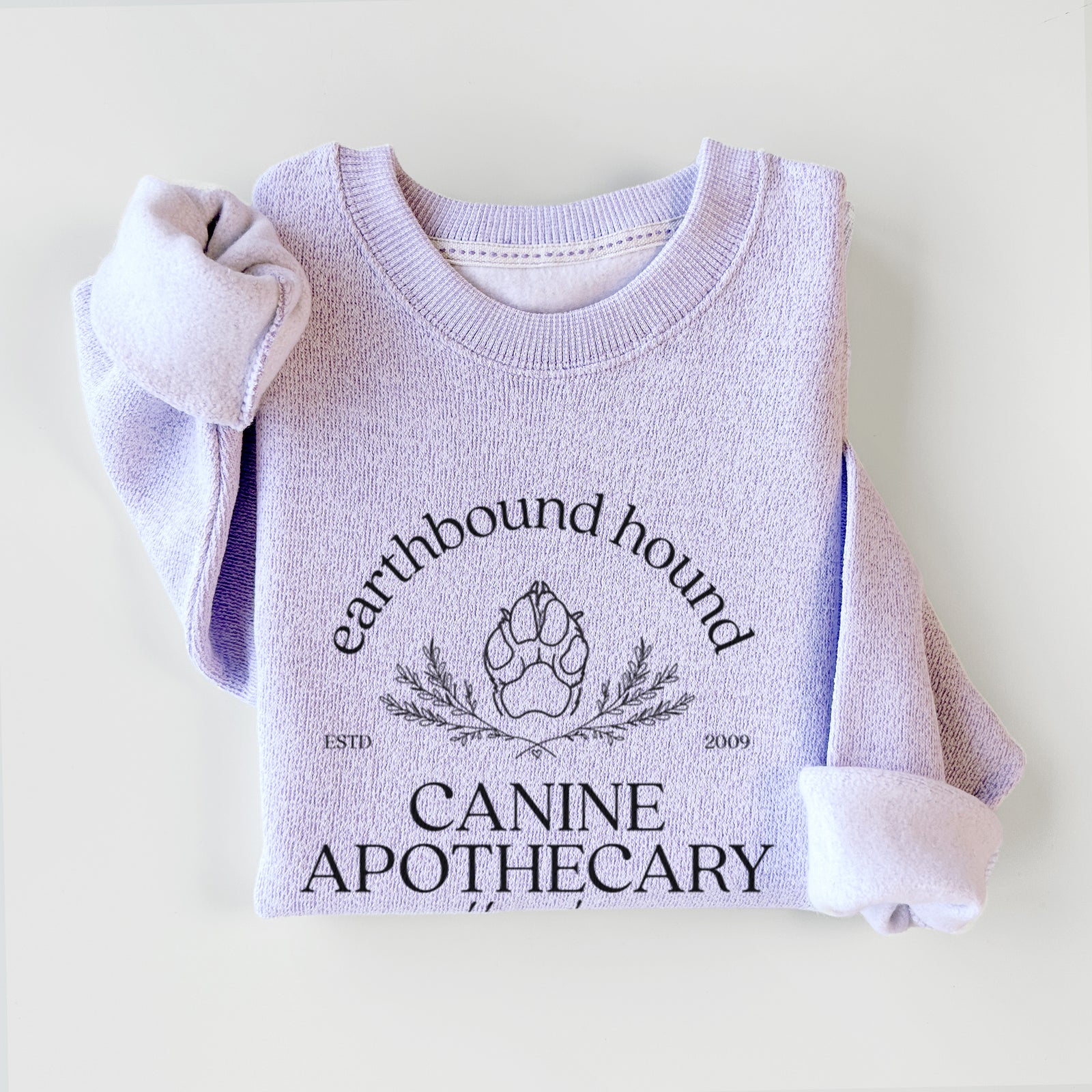 'Earthbound Hound – Canine Apothecary' design on an Ice Purple knit sweatshirt