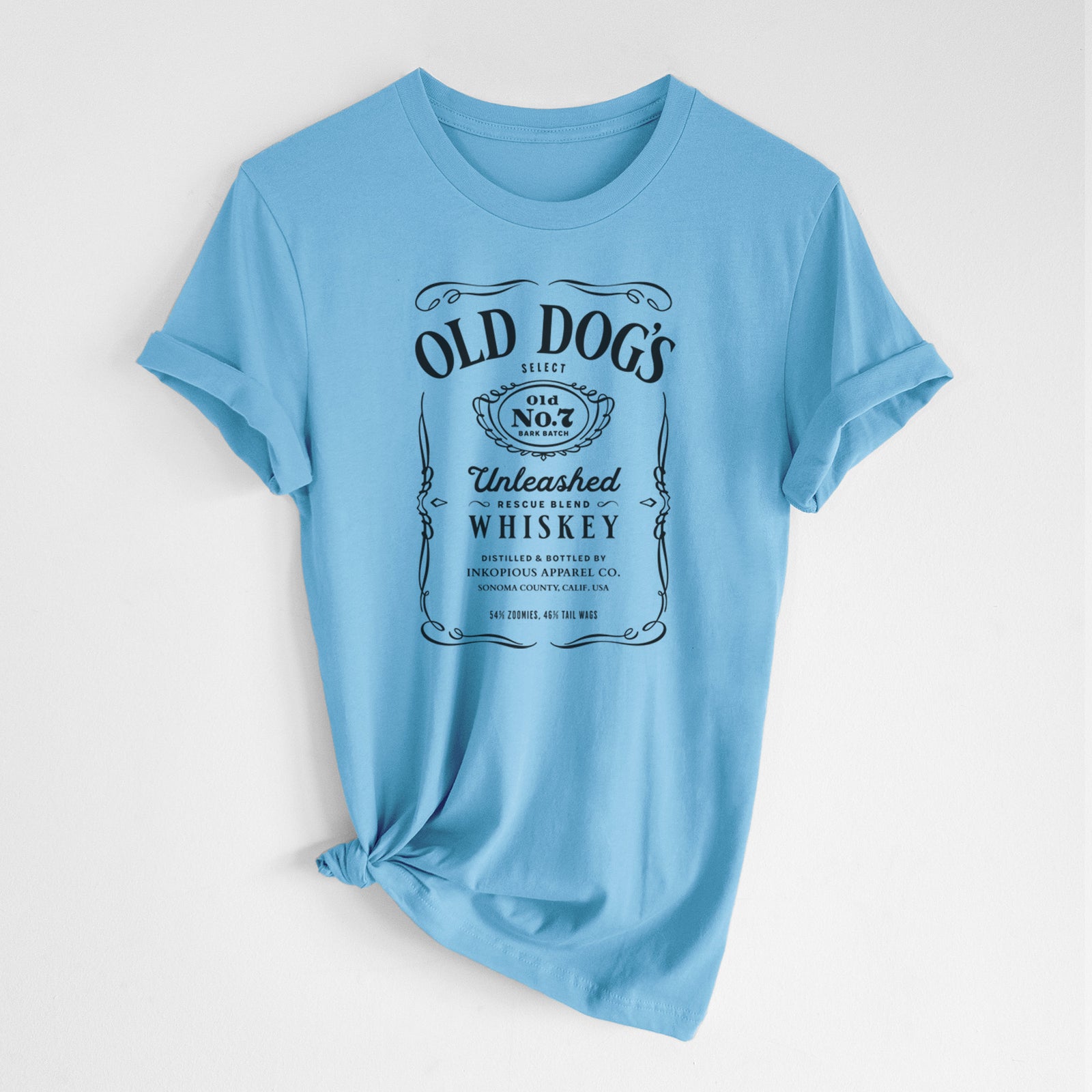 'Old Dog’s No. 7 – Unleashed Whiskey' design on an Ocean Blue Unisex crewneck, worn by a woman