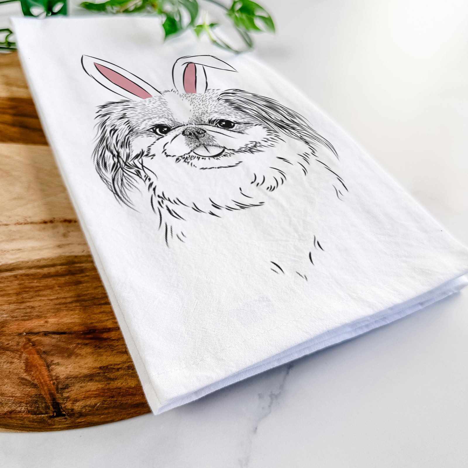 Hand-drawn sketch of Abra Bean the Pekingese wearing Easter bunny ears on a tea towel