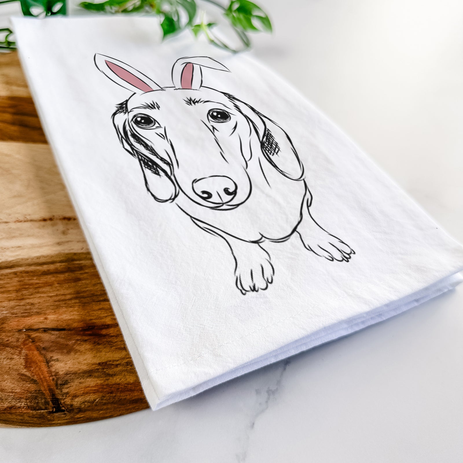 Hand-drawn sketch of Annabelle the Dachshund wearing Easter bunny ears on a tea towel