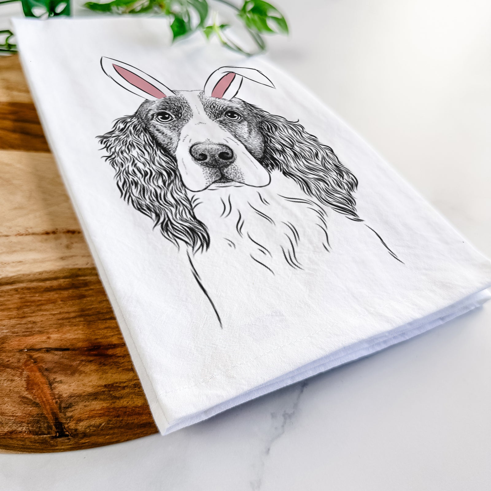 Hand-drawn sketch of Annie the English Springer Spaniel wearing Easter bunny ears on a tea towel