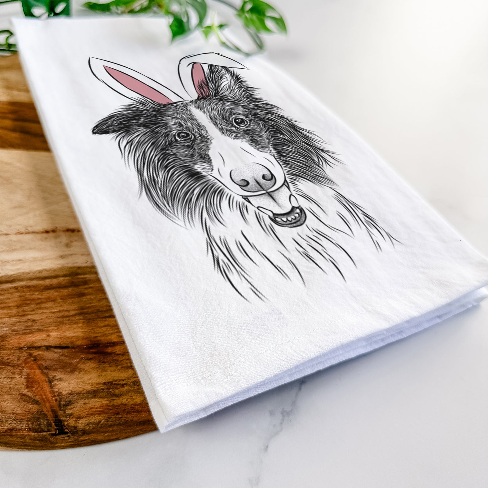 Hand-drawn sketch of Archie the Silken Windhound wearing Easter bunny ears on a tea towel