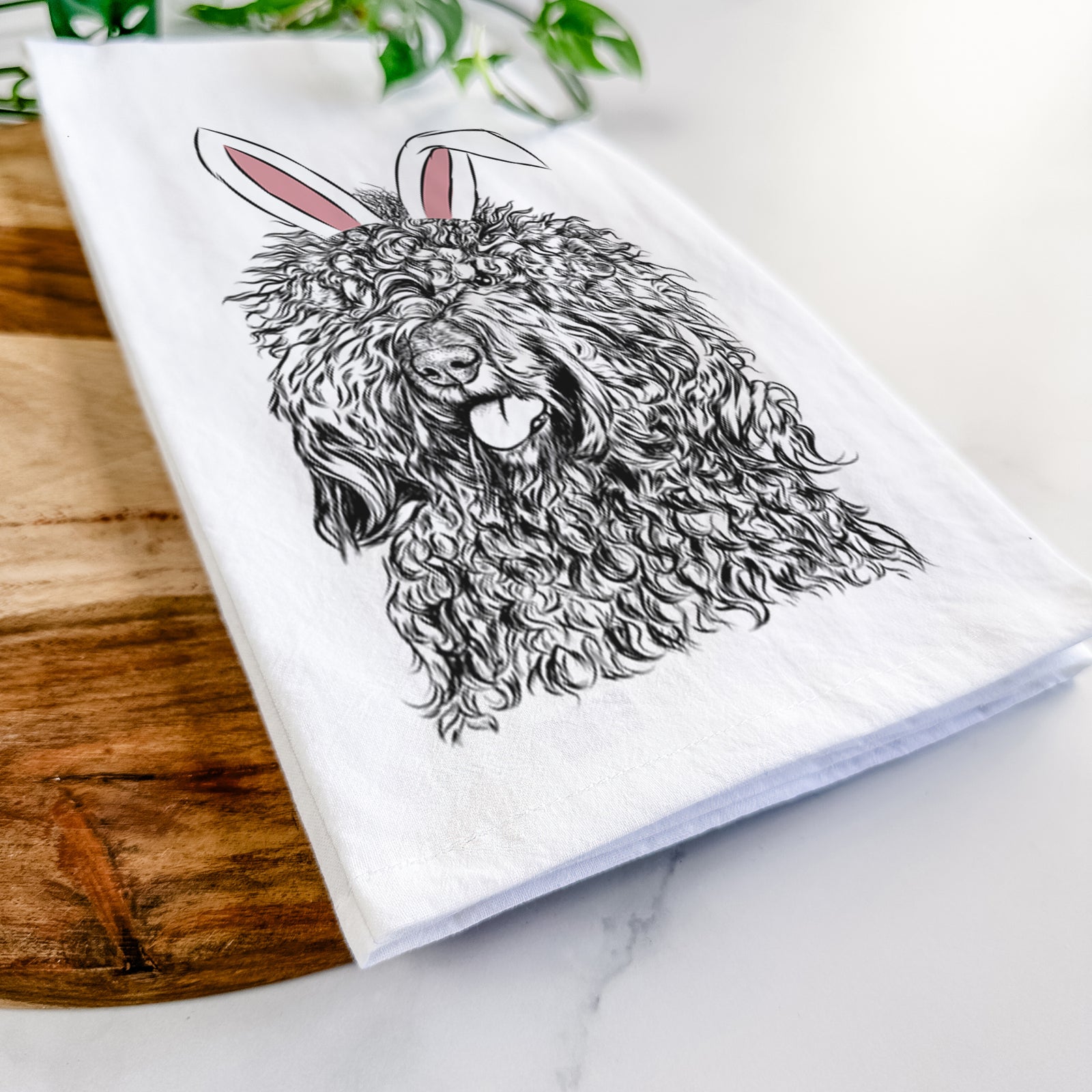 Hand-drawn sketch of Babs the Barbet wearing Easter bunny ears on a tea towel