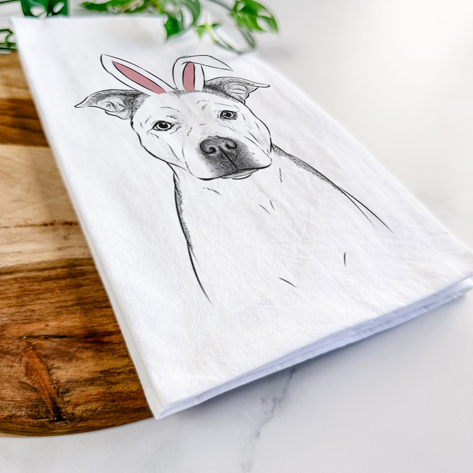 Hand-drawn sketch of Bailey the Pitbull wearing Easter bunny ears on a tea towel