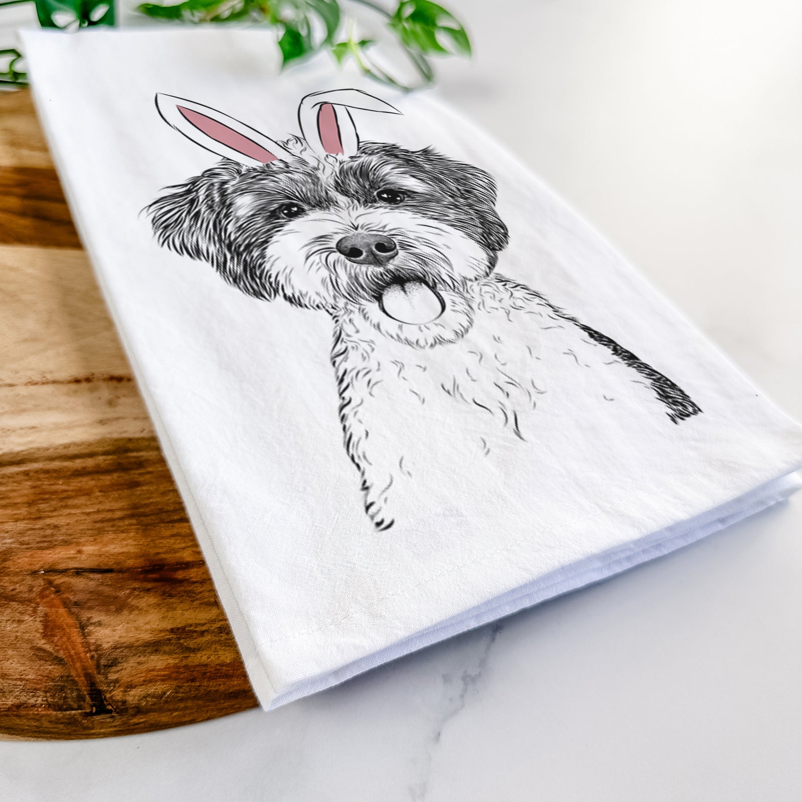Hand-drawn sketch of Bella the Cockapoo wearing Easter bunny ears on a tea towel