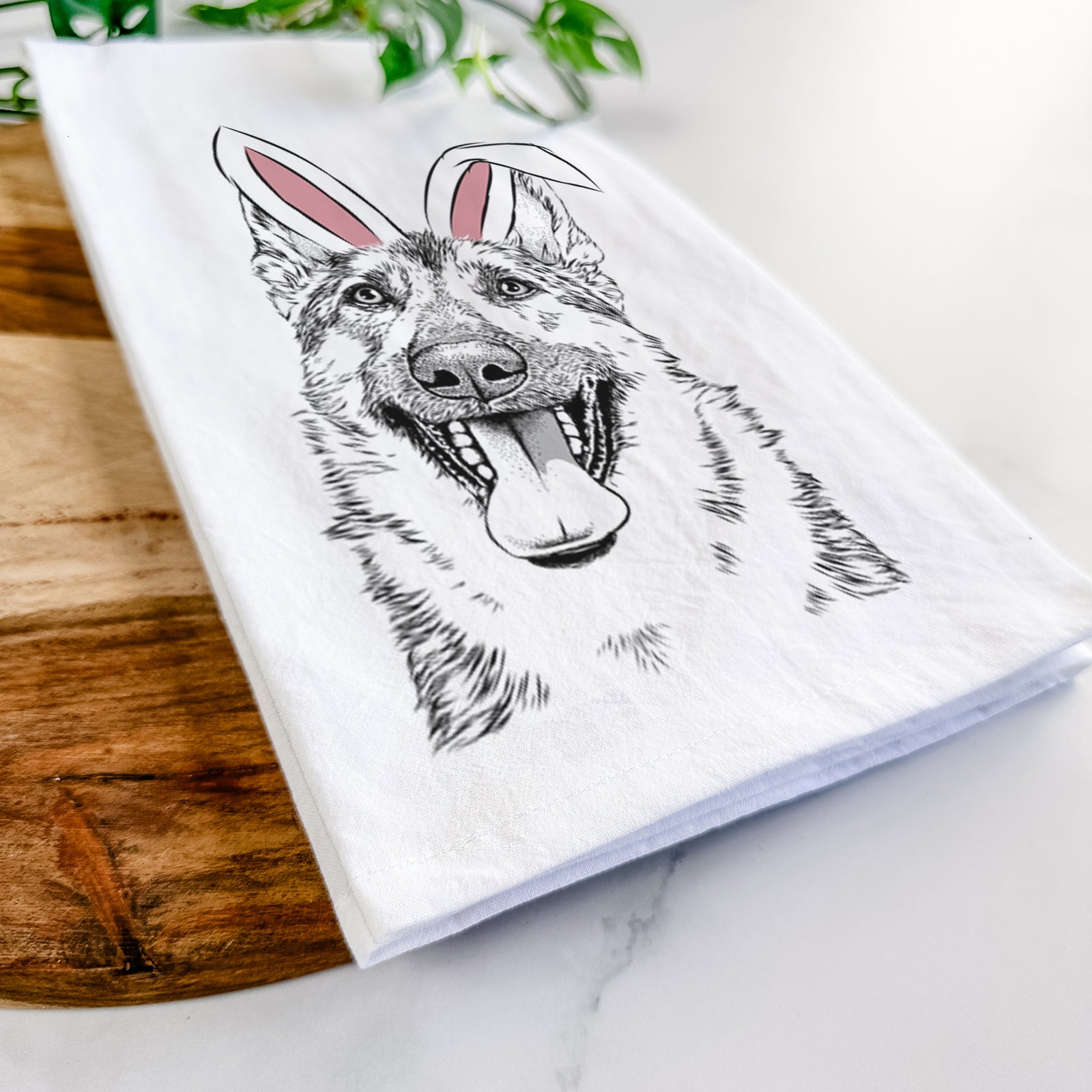 Hand-drawn sketch of Benson the German Shepherd wearing Easter bunny ears on a tea towel