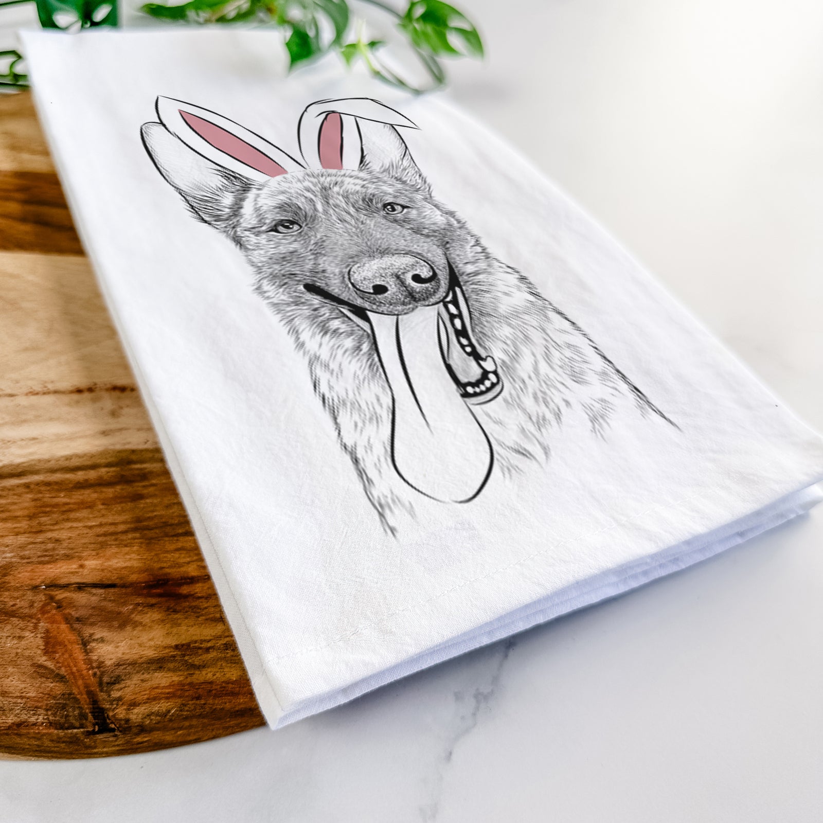 Hand-drawn sketch of Bessa the Dutch Shepherd wearing Easter bunny ears on a tea towel