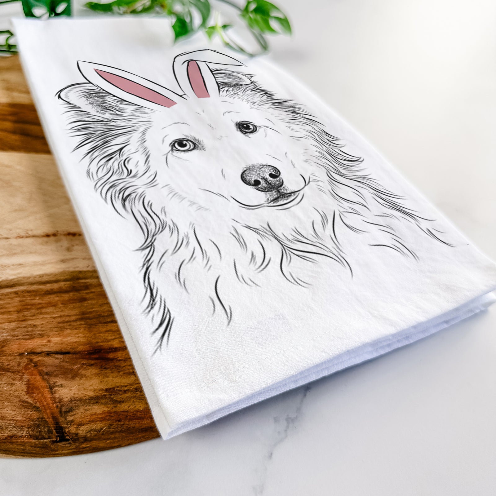 Hand-drawn sketch of Bonsai the Mixed Breed wearing Easter bunny ears on a tea towel