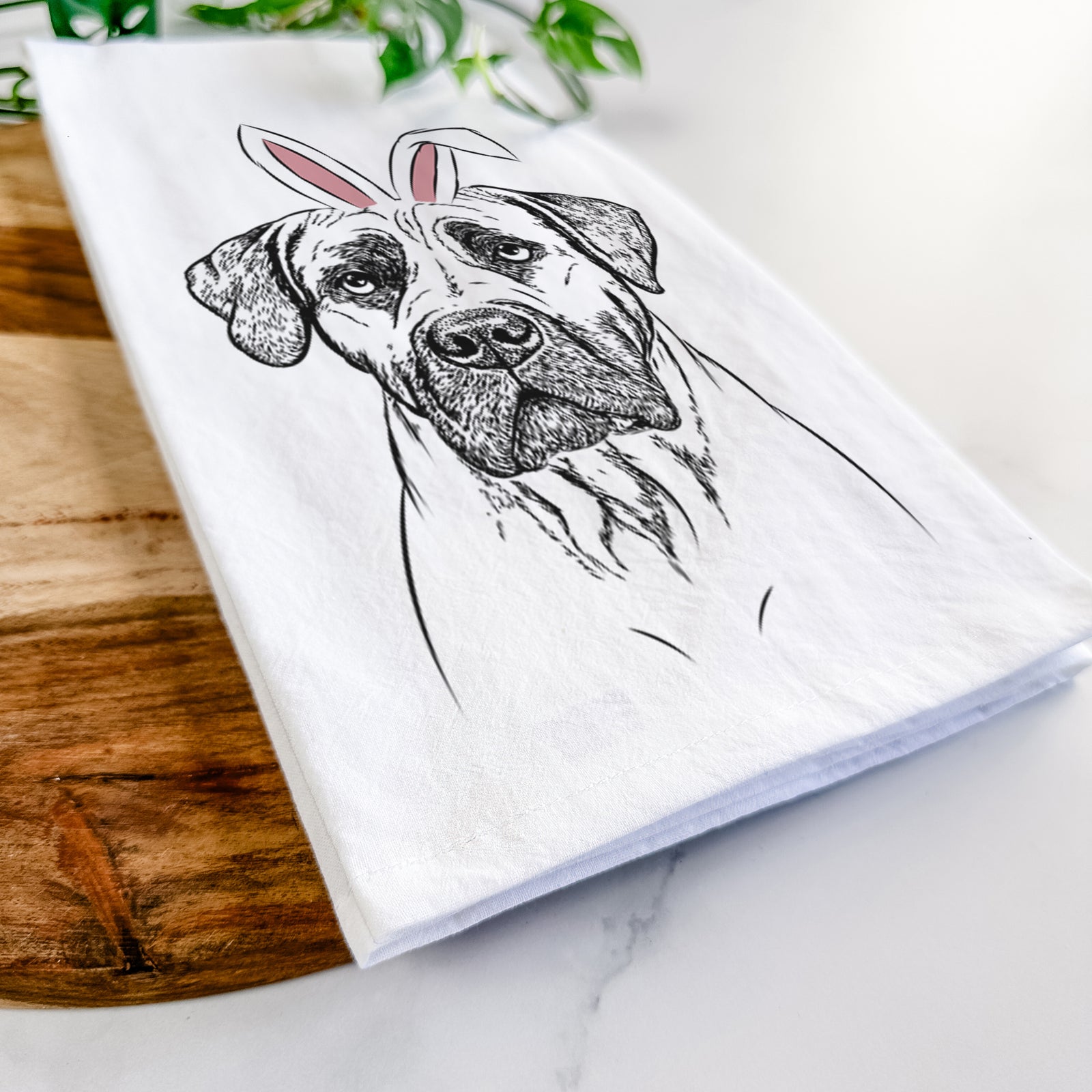 Hand-drawn sketch of Boris the Boerboel wearing Easter bunny ears on a tea towel