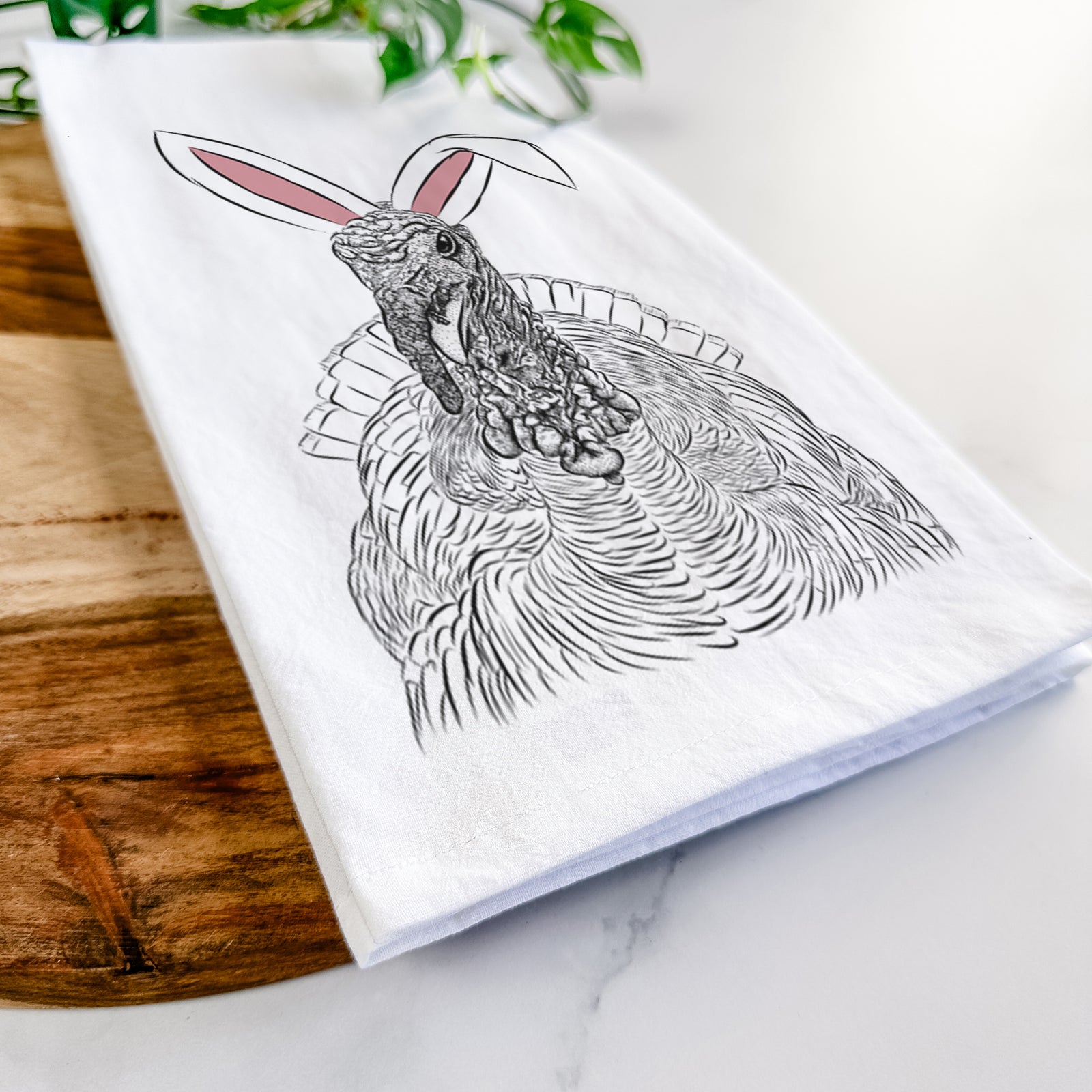 Hand-drawn sketch of Brady the Turkey wearing Easter bunny ears on a tea towel