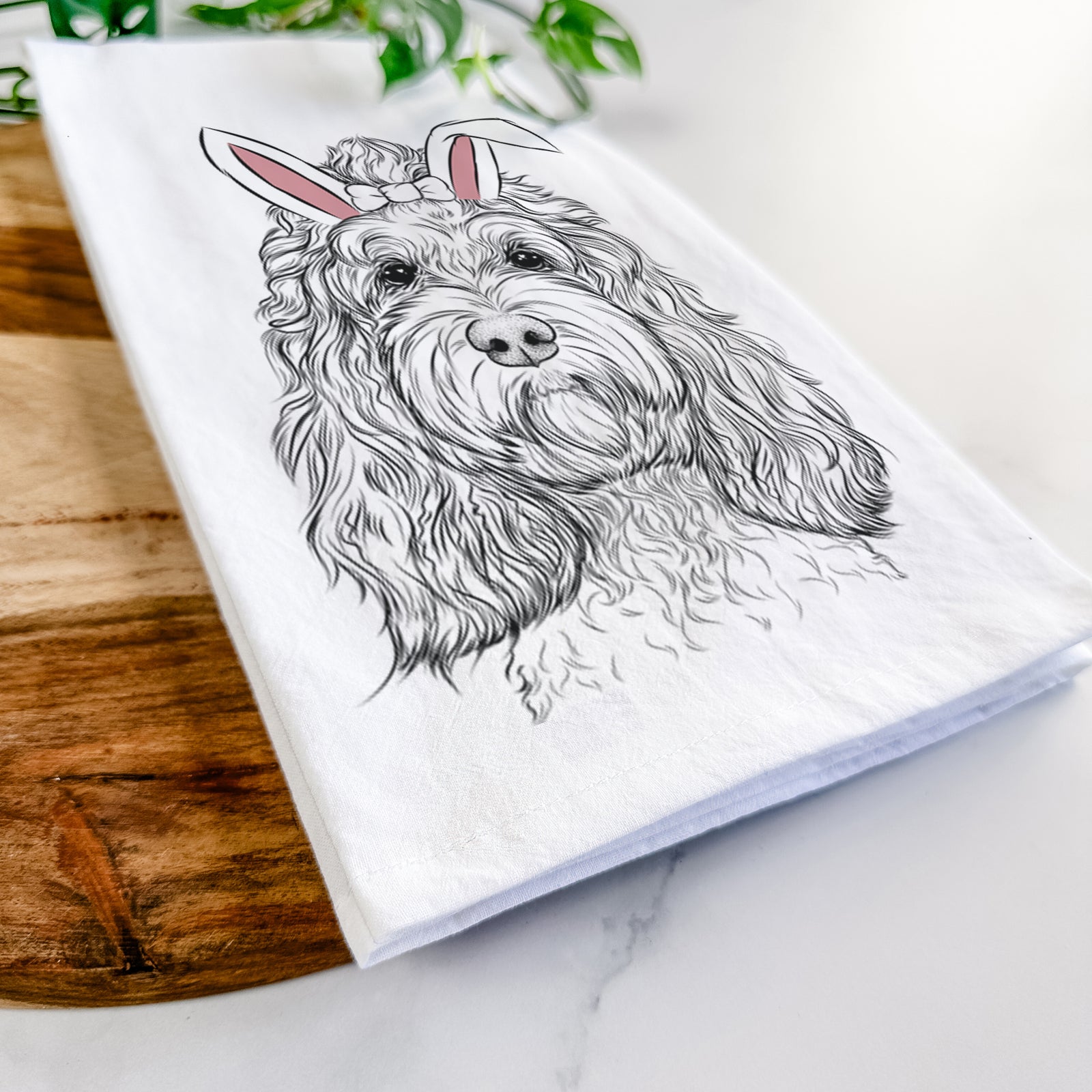 Hand-drawn sketch of Chloe the Cockapoo wearing Easter bunny ears on a tea towel