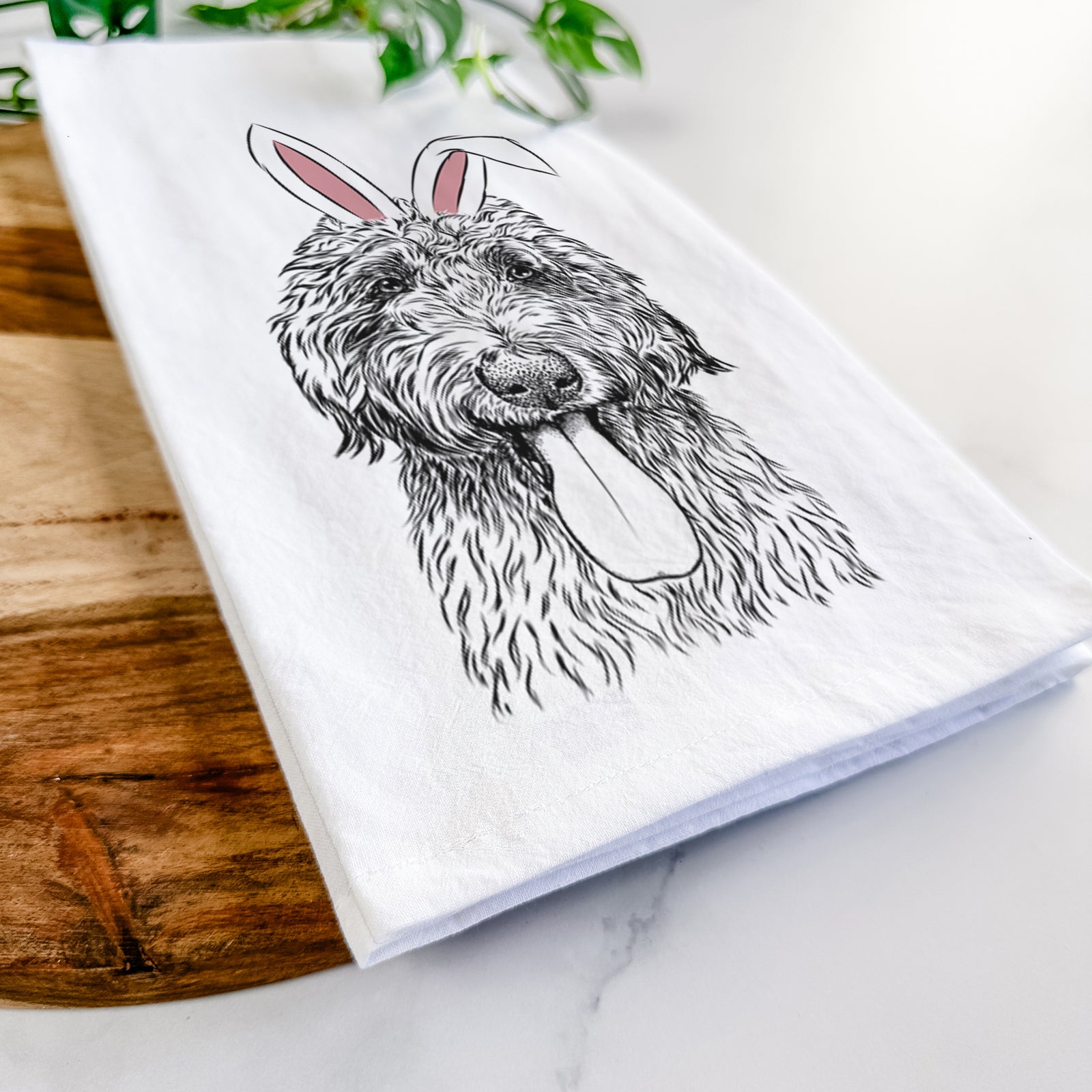 Hand-drawn sketch of CiCi Paulk the Aussiedoodle wearing Easter bunny ears on a tea towel