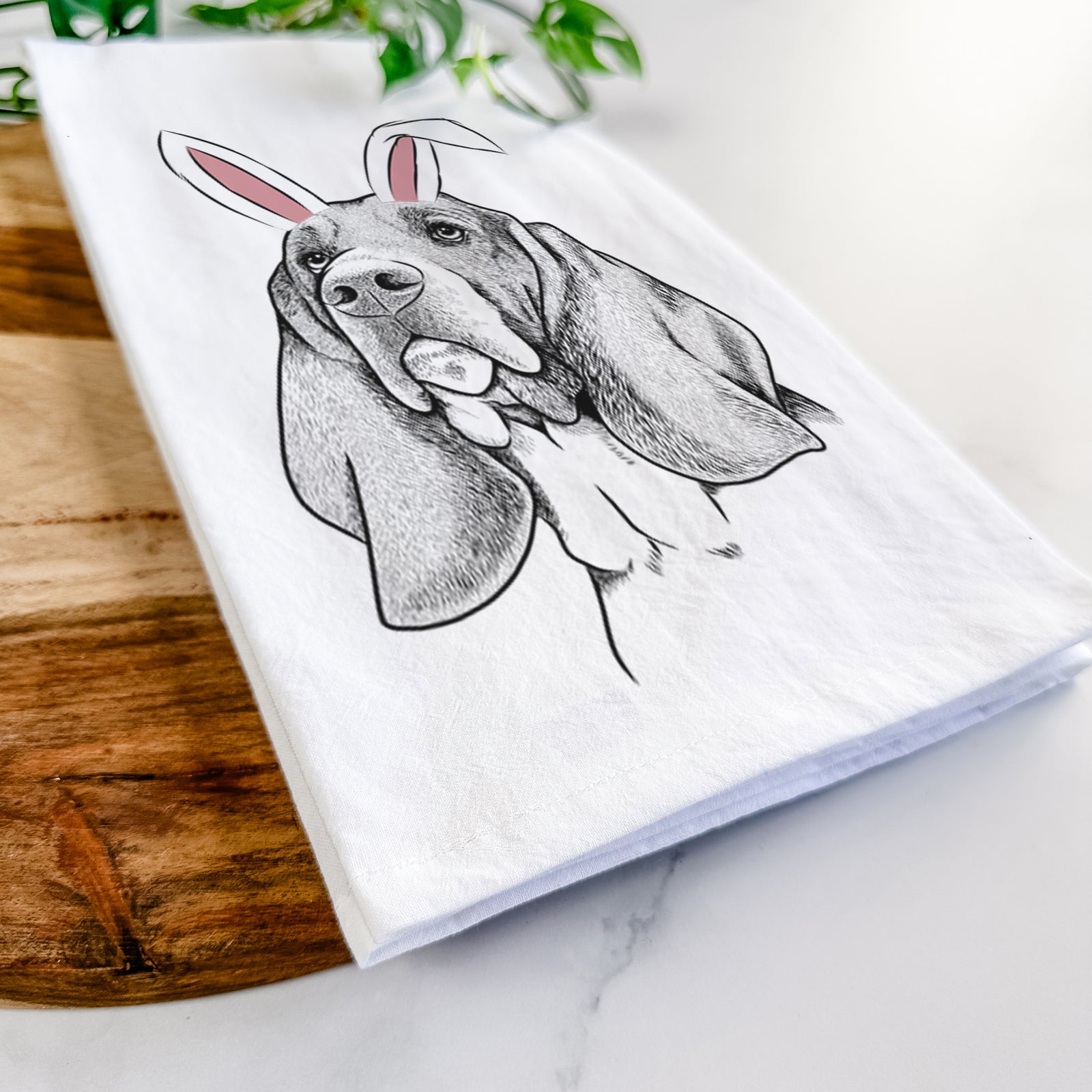 Hand-drawn sketch of Cooper the Basset Hound wearing Easter bunny ears on a tea towel