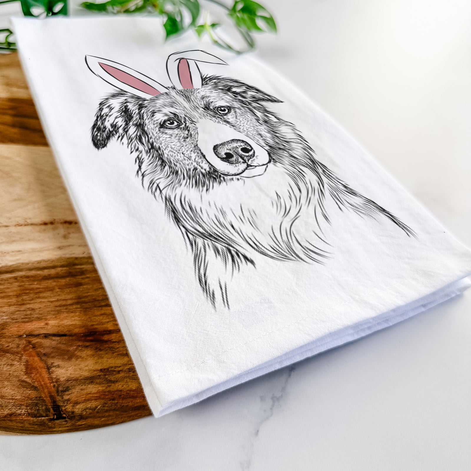 Hand-drawn sketch of Cynder the English Shepherd wearing Easter bunny ears on a tea towel