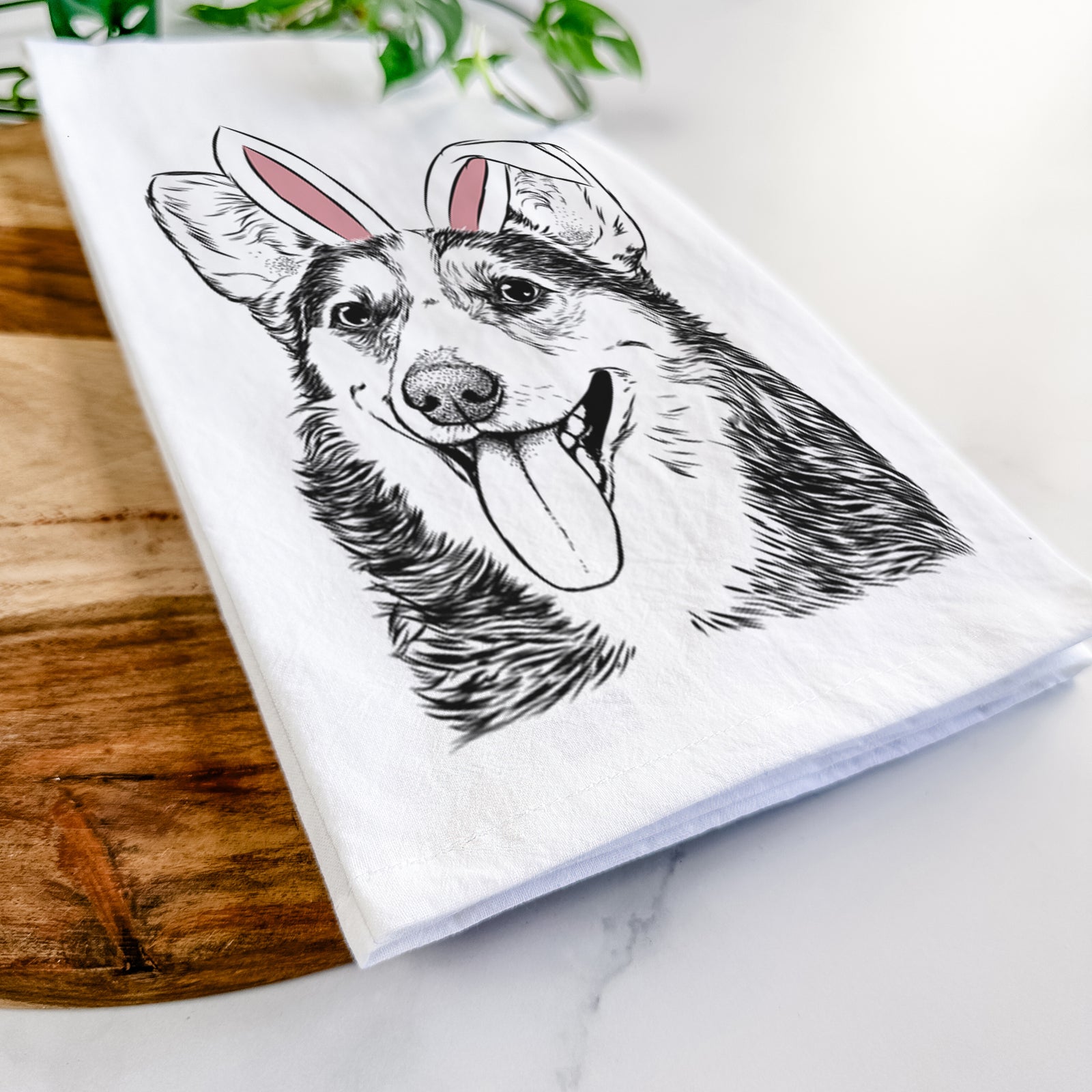 Hand-drawn sketch of Darma the Corgi wearing Easter bunny ears on a tea towel