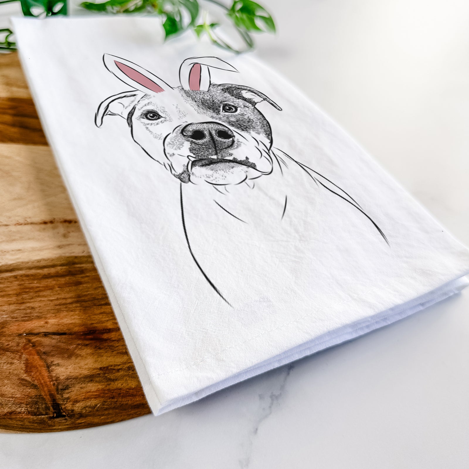 Hand-drawn sketch of Dexter the Pitbull wearing Easter bunny ears on a tea towel
