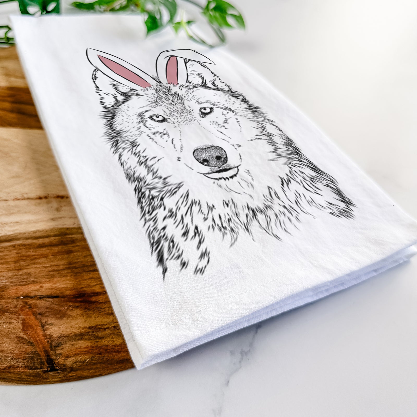 Hand-drawn sketch of Django the Grey Wolf wearing Easter bunny ears on a tea towel