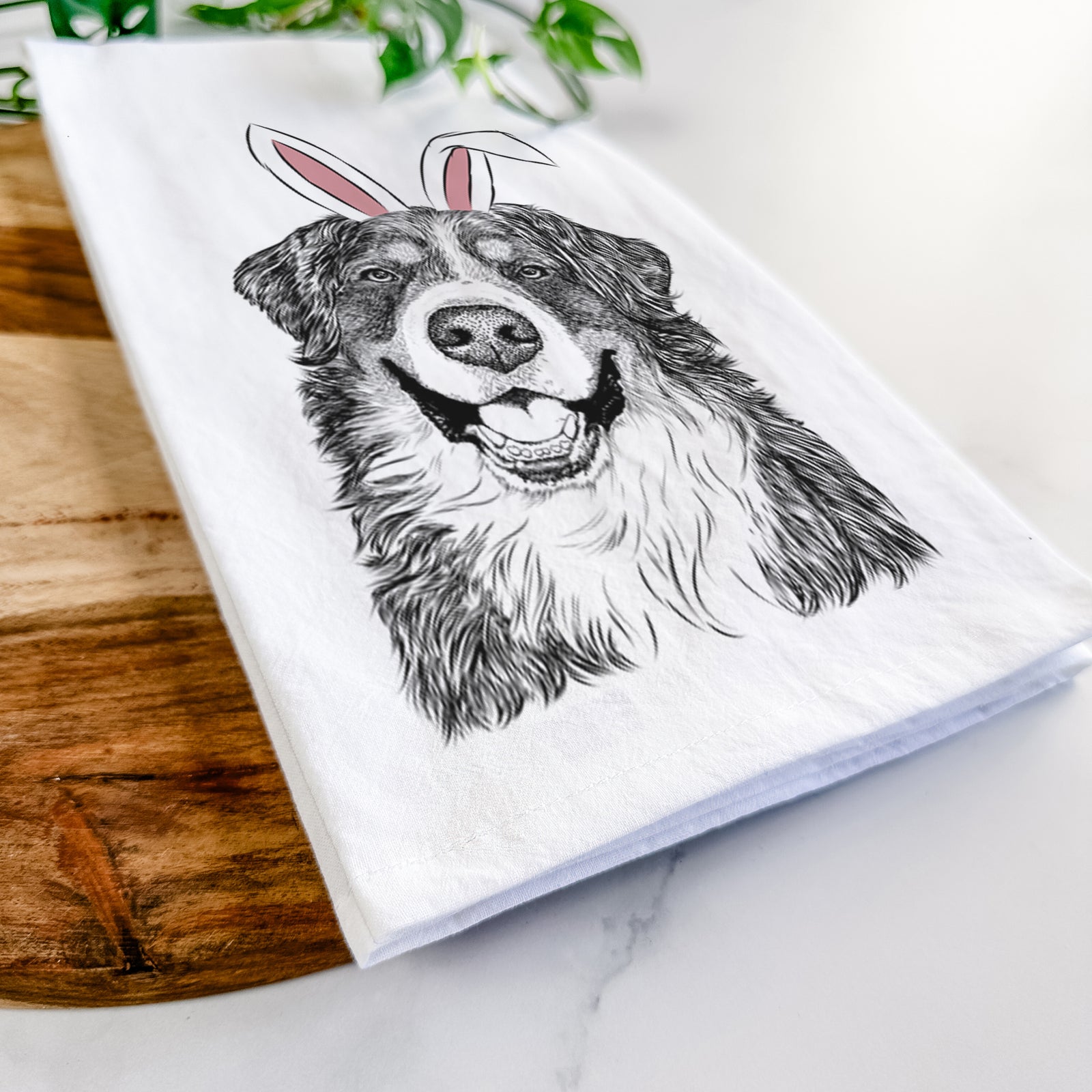 Hand-drawn sketch of Eiger the Bernese Mountain Dog wearing Easter bunny ears on a tea towel