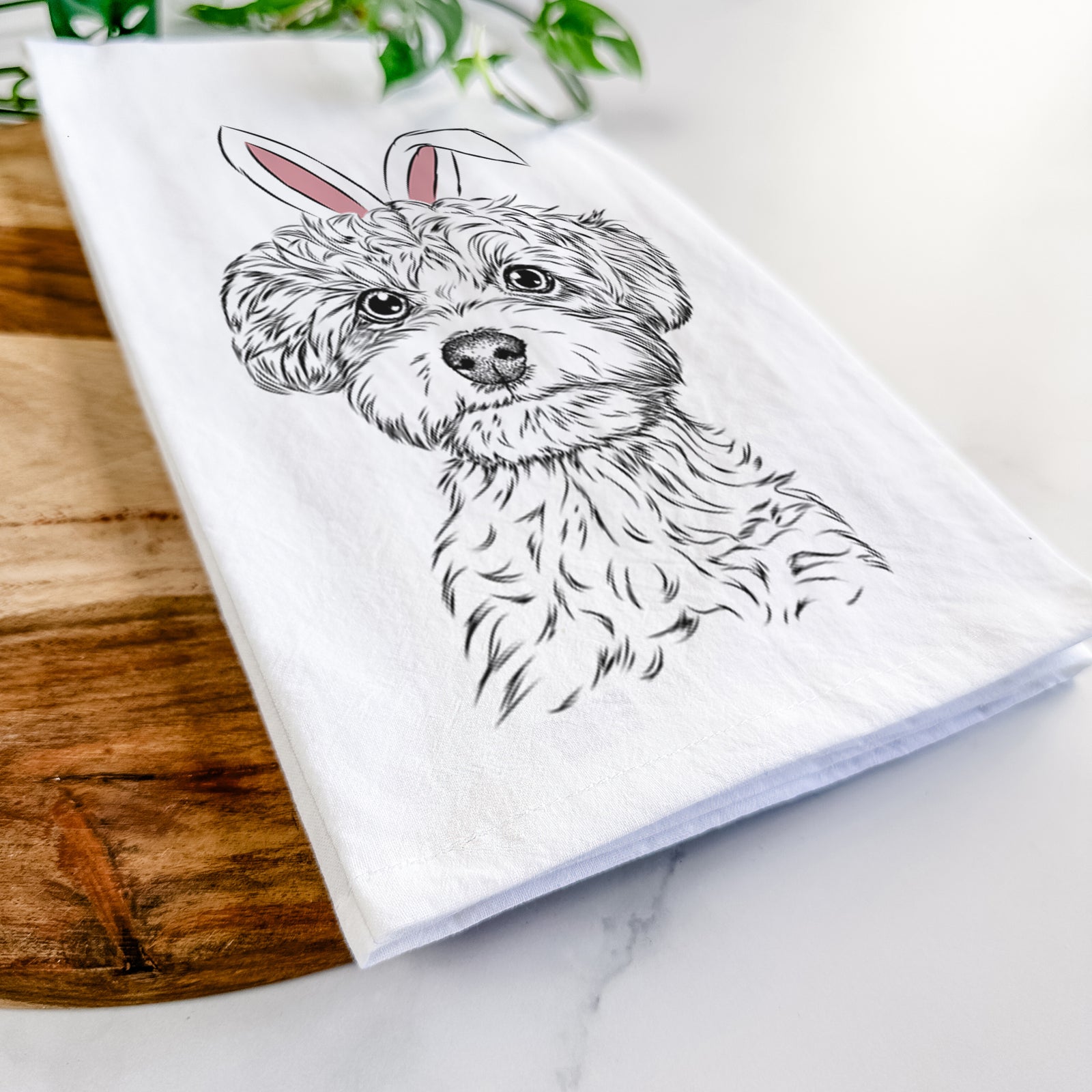 Hand-drawn sketch of Elliott the Yorkiepoo wearing Easter bunny ears on a tea towel