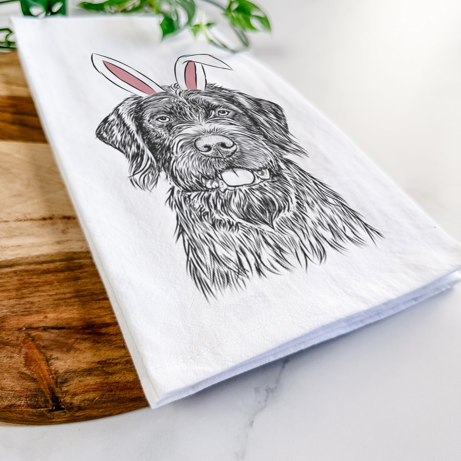 Hand-drawn sketch of Fletcher the Wirehaired Pointing Griffon wearing Easter bunny ears on a tea towel