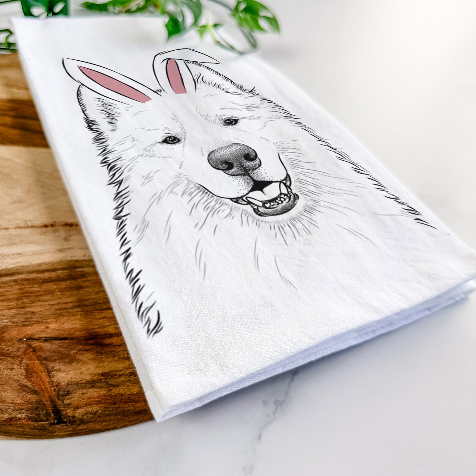 Hand-drawn sketch of Foster the Samoyed wearing Easter bunny ears on a tea towel