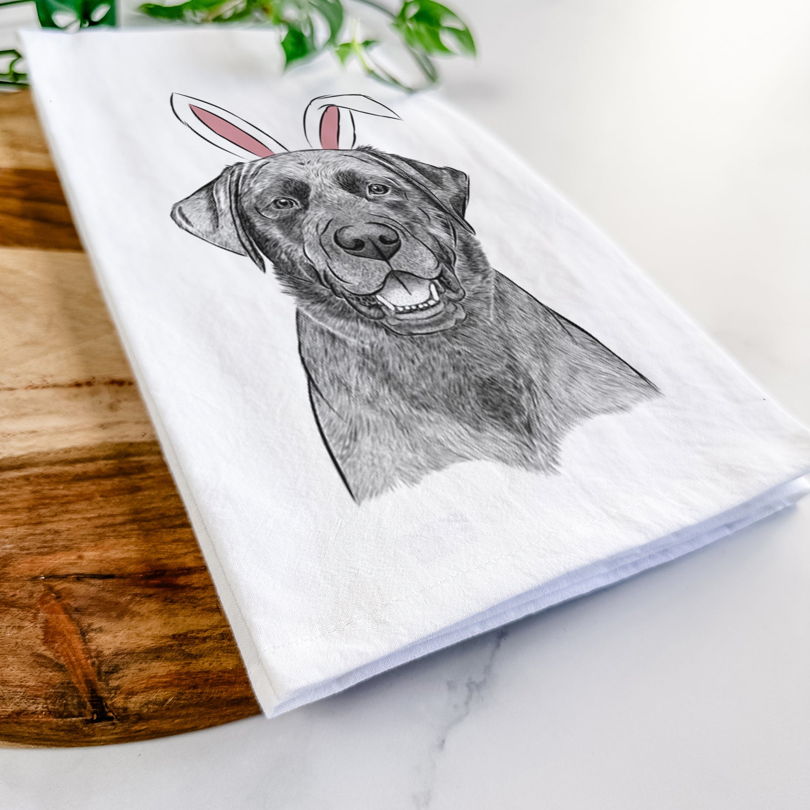 Hand-drawn sketch of Heath the Black Lab wearing Easter bunny ears on a tea towel